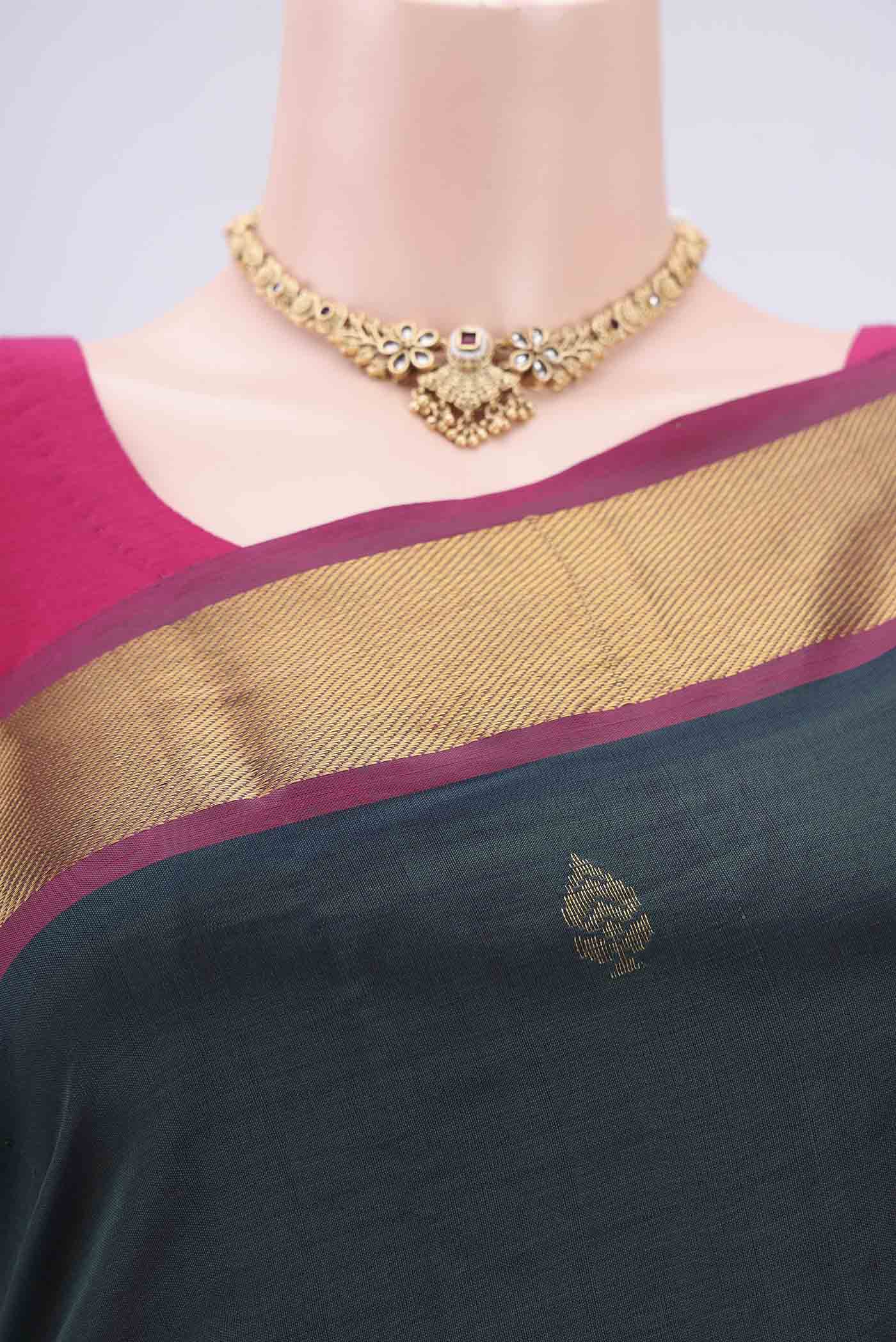 Border image of Bottle Green Blended Poly Cotton Saree with Zari Butta on the body and Thread Border. 
