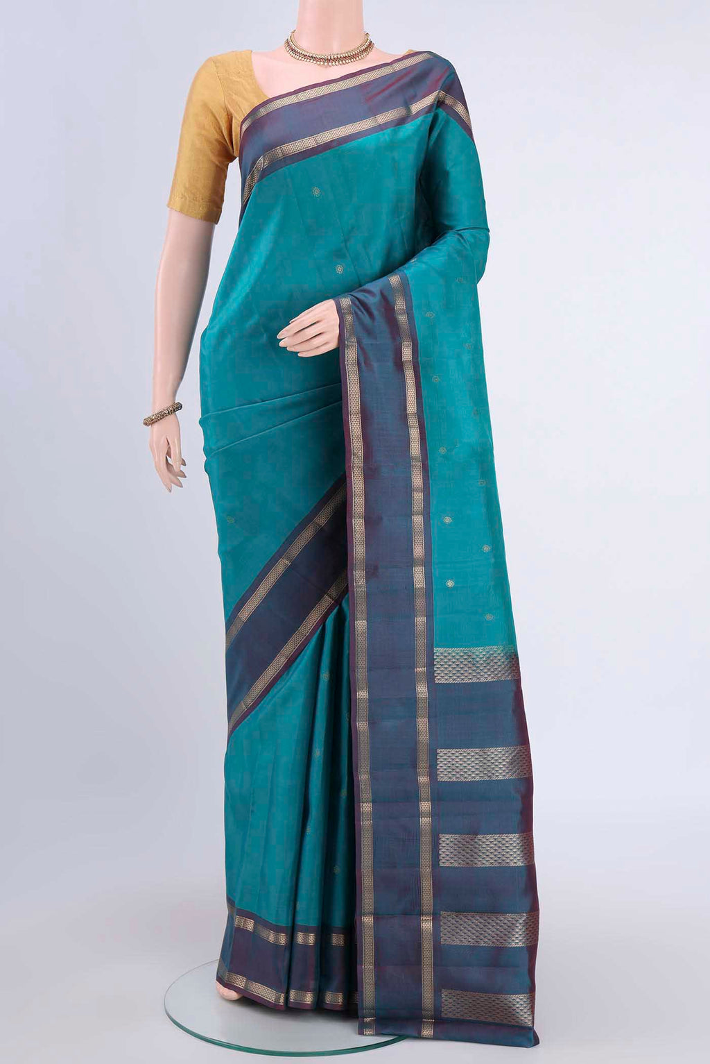 Blue Kanchipuram Silk Saree with Zari Butta on the body and Zari Border displayed on a mannequin
