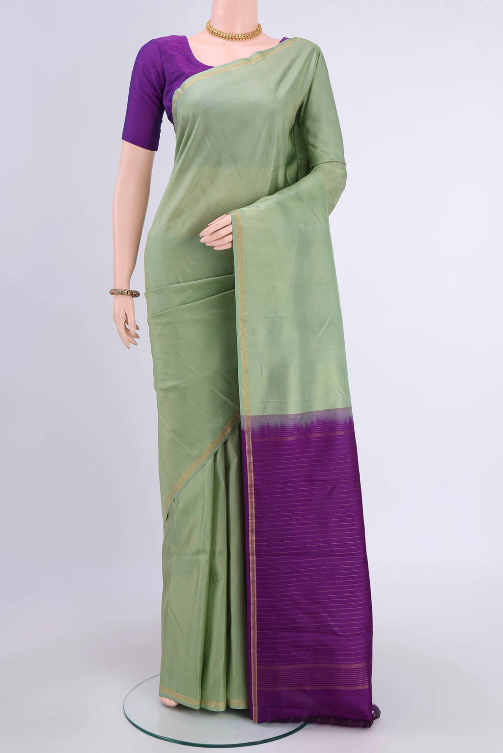 Pista Green Nangavalli Silk [ Salem ] Saree with Zari Butta on the body and Thin Zari Line displayed on a mannequin