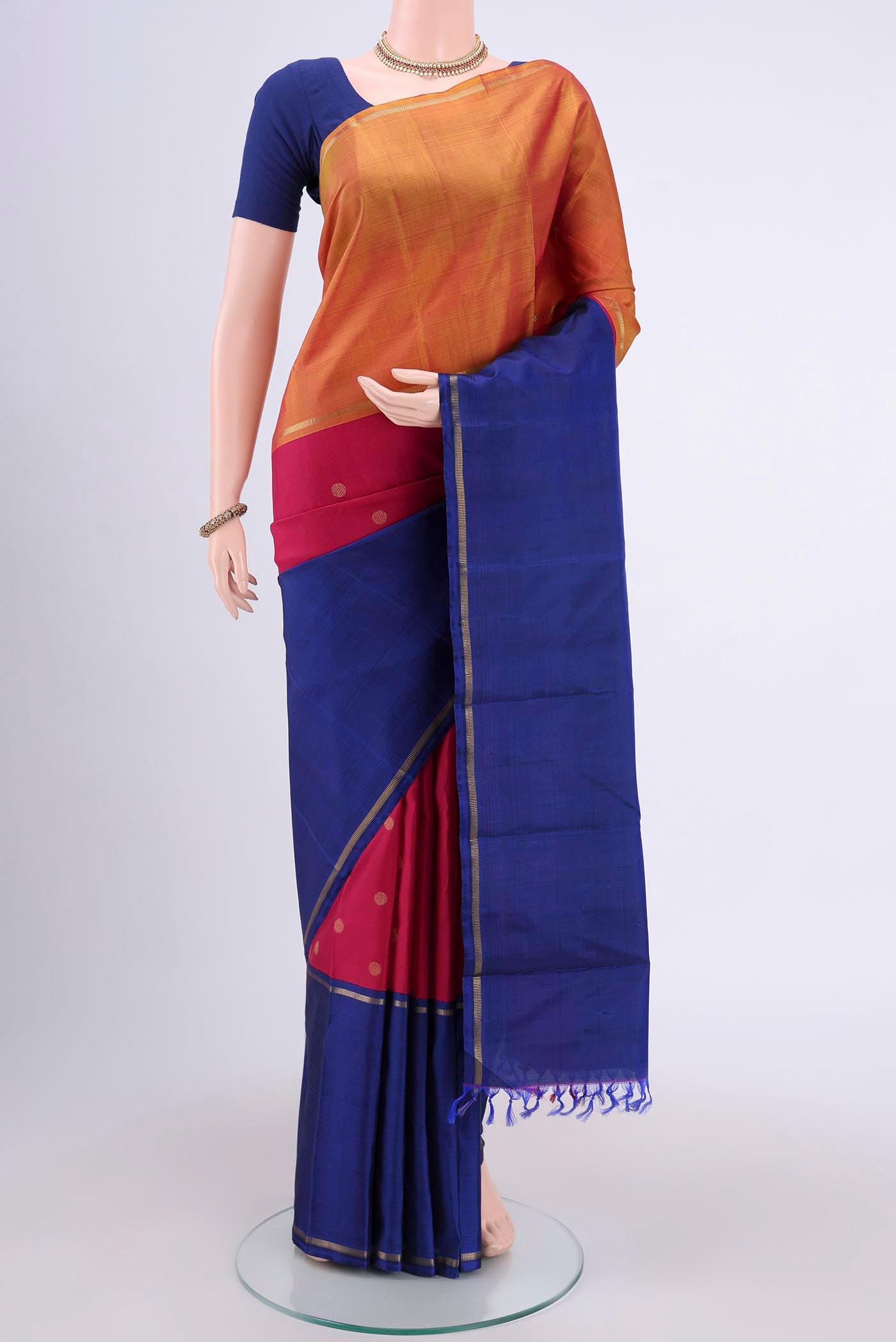 Pure Silk Pure Zari Maroon Kanchipuram Saree with Zari Butta on the body and Ganga Jamuna Border.  displayed on a mannequin