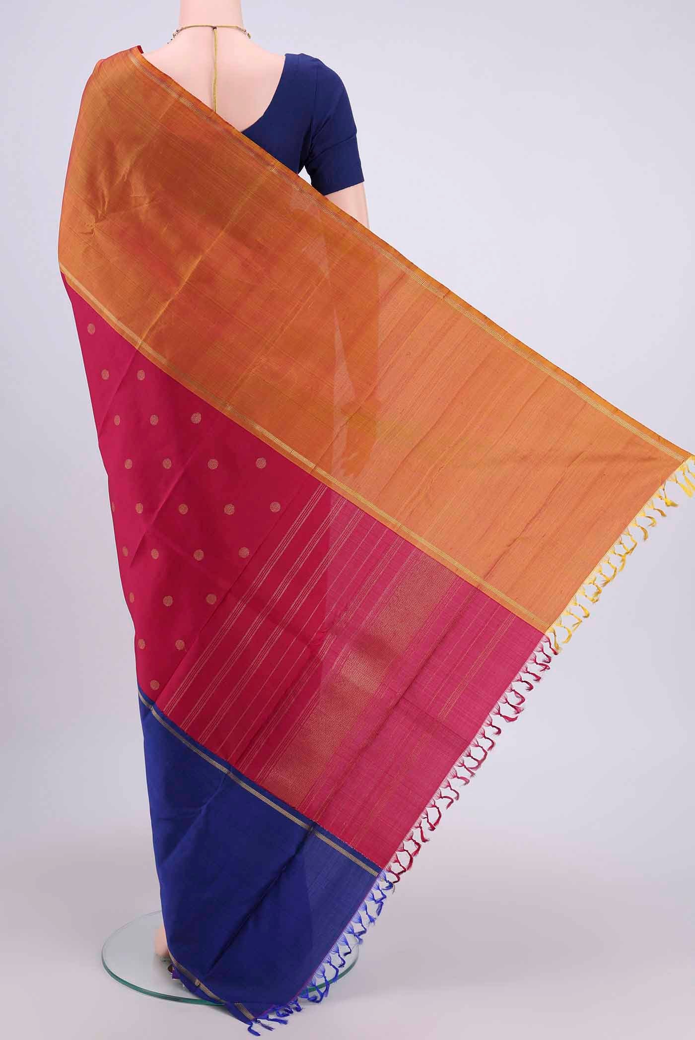 Flat view of Pure Silk Pure Zari Maroon Kanchipuram Saree with Zari Butta on the body and Ganga Jamuna Border. 