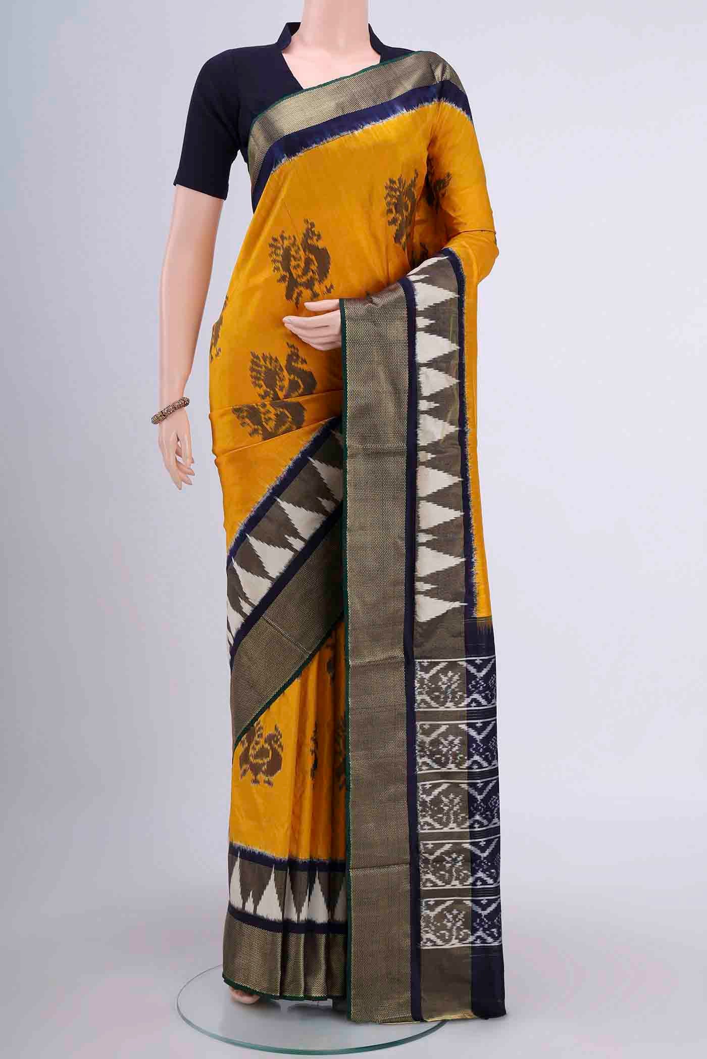 Yellow Pochampally Silk Saree with Pure Ikat on the body and Zari Border displayed on a mannequin