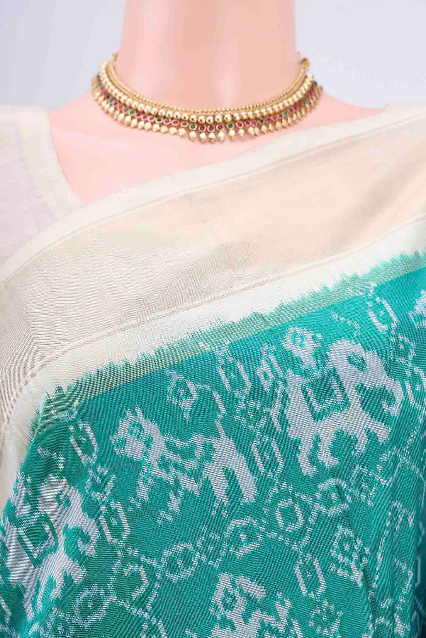 Border image of Turquoise Pochampally Silk Saree with Pure Ikat on the body and Zari Border
