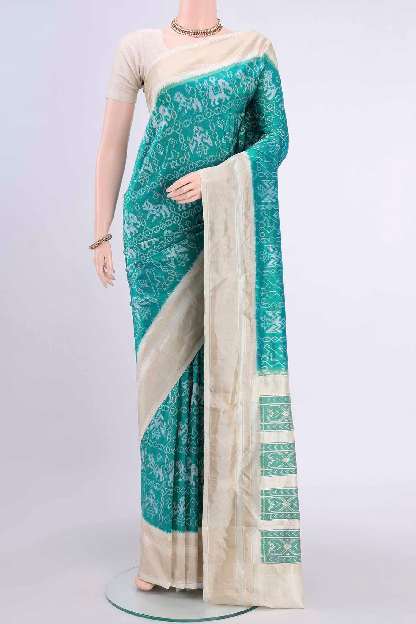 Turquoise Pochampally Silk Saree with Pure Ikat on the body and Zari Border displayed on a mannequin