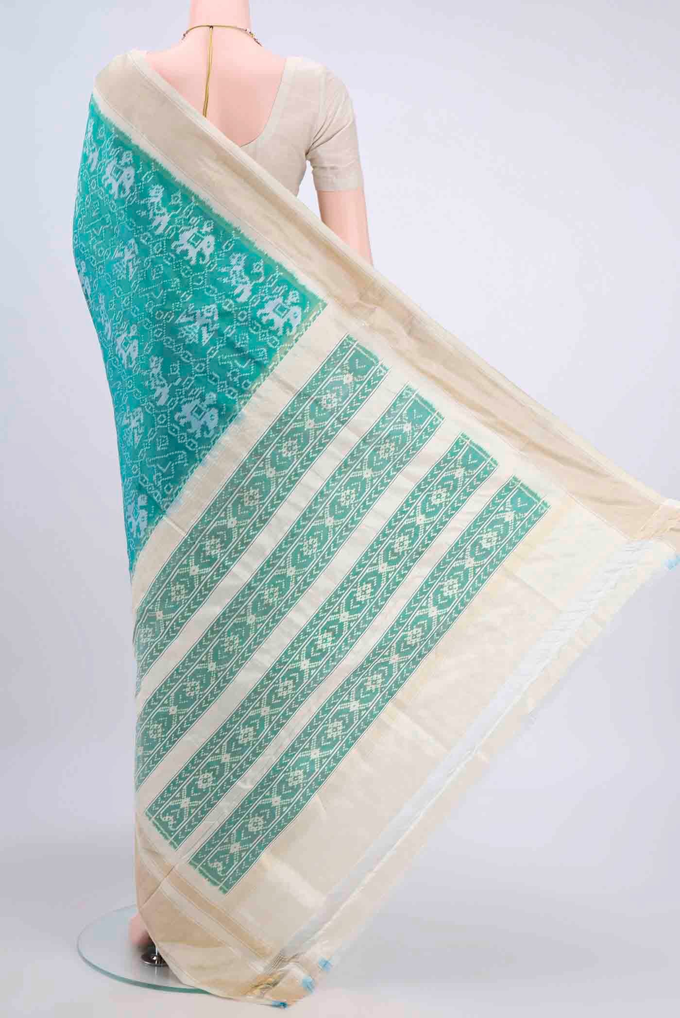 Flat view of Turquoise Pochampally Silk Saree with Pure Ikat on the body and Zari Border