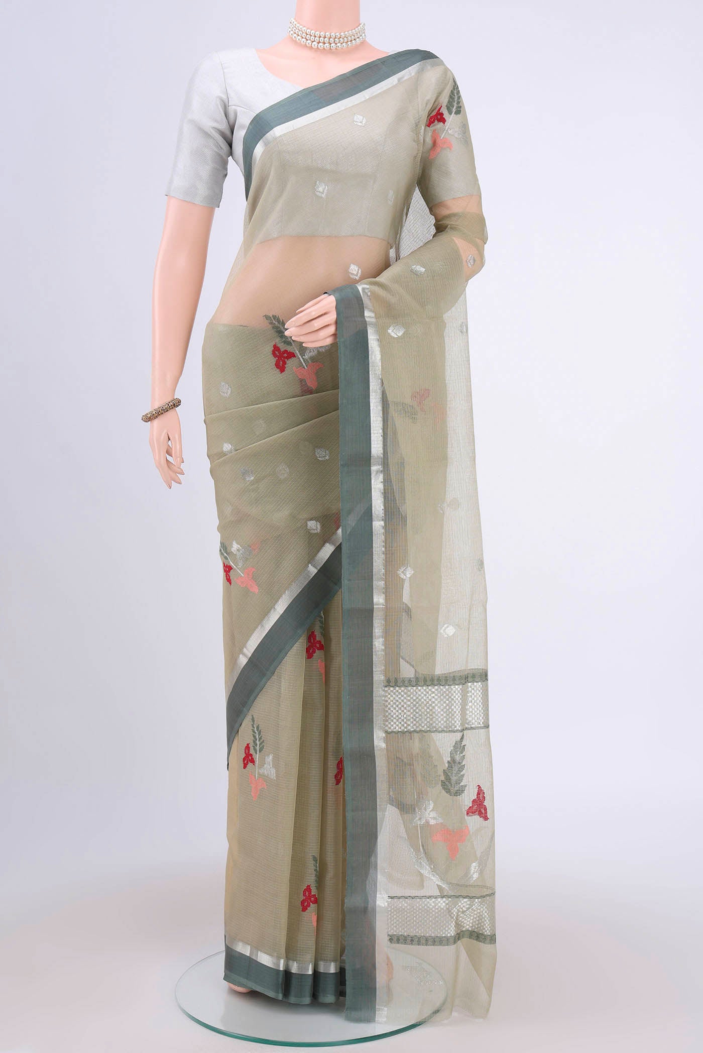 Pure Silk Pure Zari Sage Green Kota Cotton Saree with Zari And Thread Butta on the body and Zari Border.  displayed on a mannequin