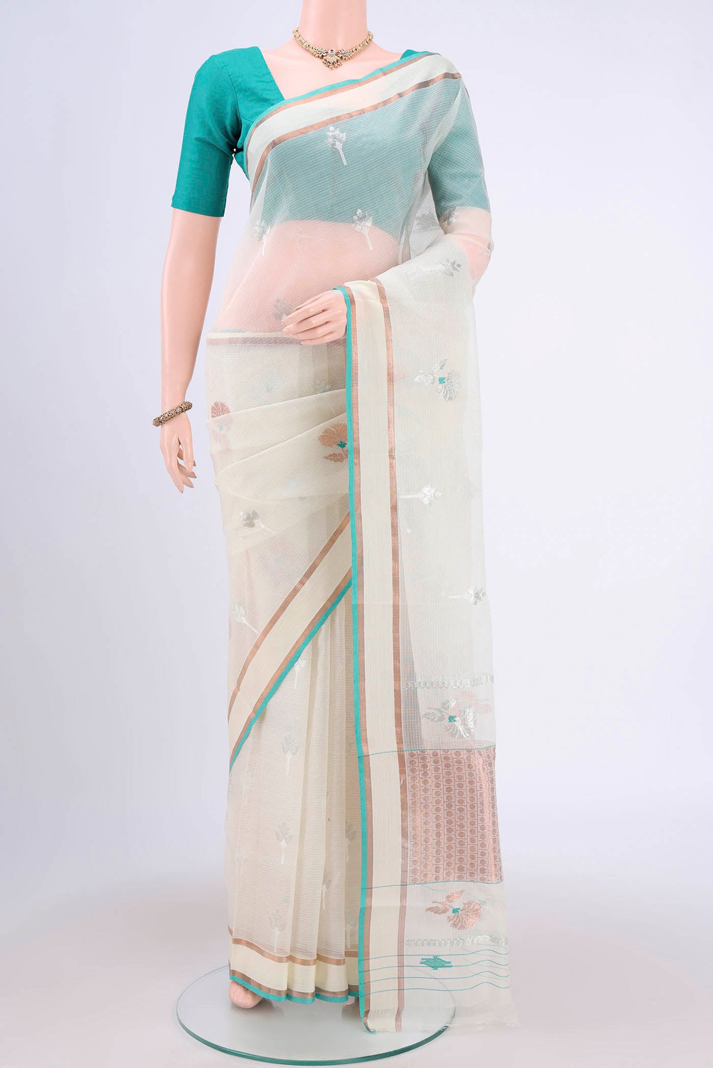 Pure Silk Pure Zari Mint Green Kota Cotton Saree with Zari And Thread Butta on the body and Zari Border.  displayed on a mannequin