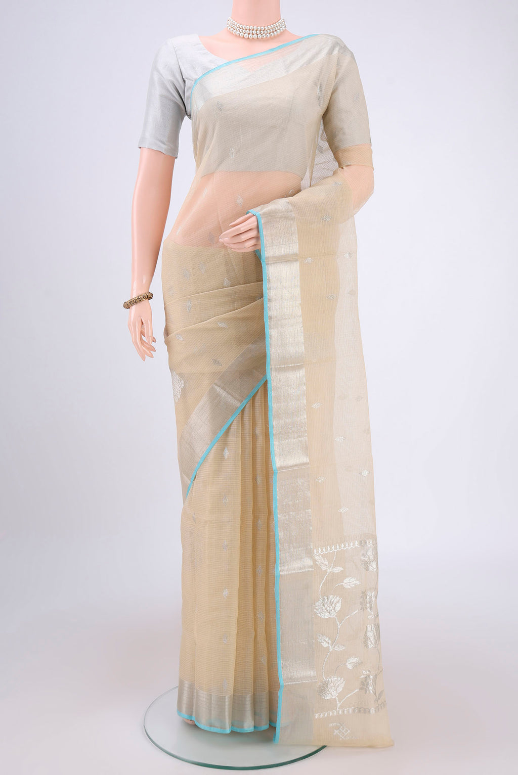 Pure Silk Pure Zari Cream Kota Saree with Zari Butta on the body and Zari Border.  displayed on a mannequin