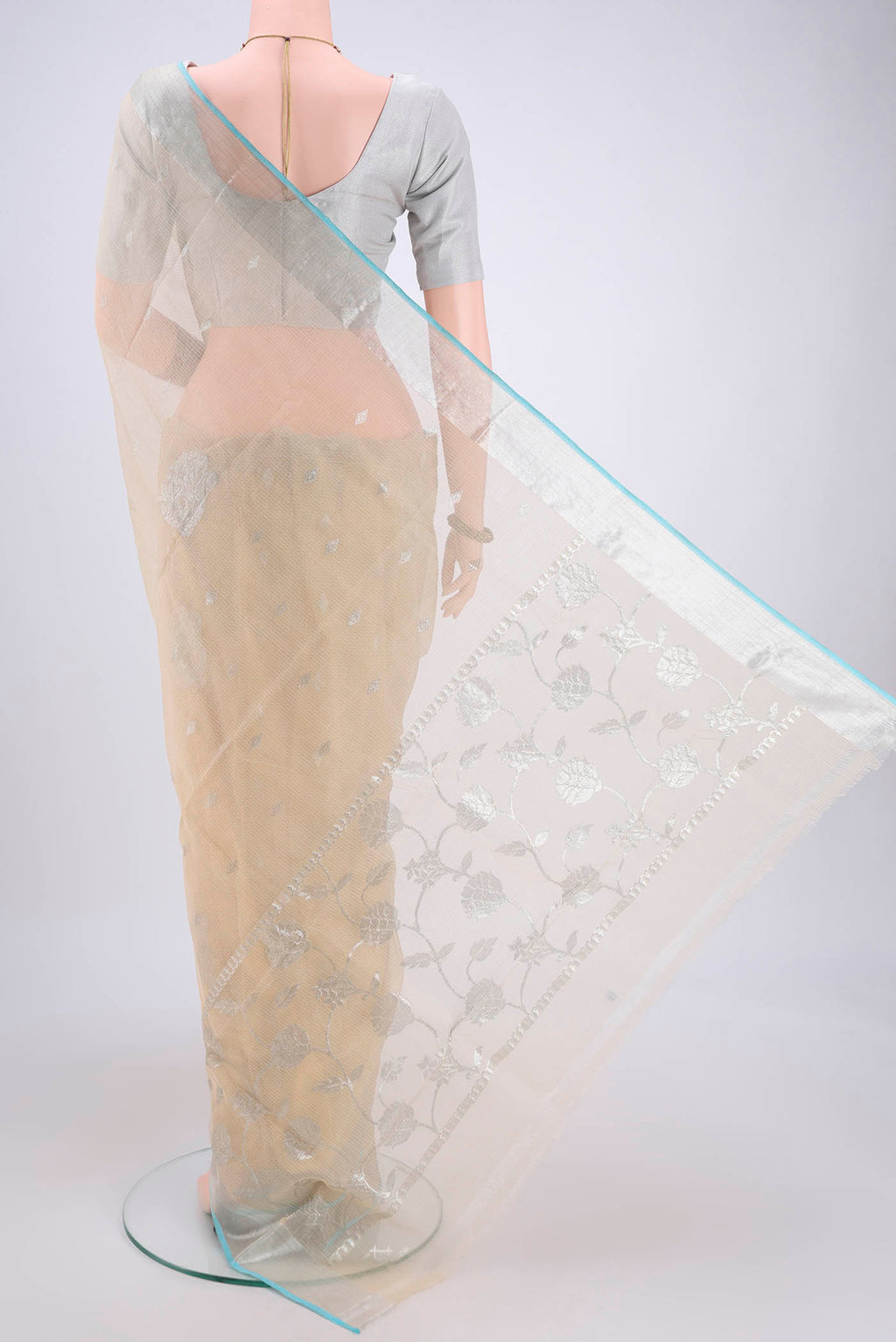 Flat view of Pure Silk Pure Zari Cream Kota Saree with Zari Butta on the body and Zari Border. 
