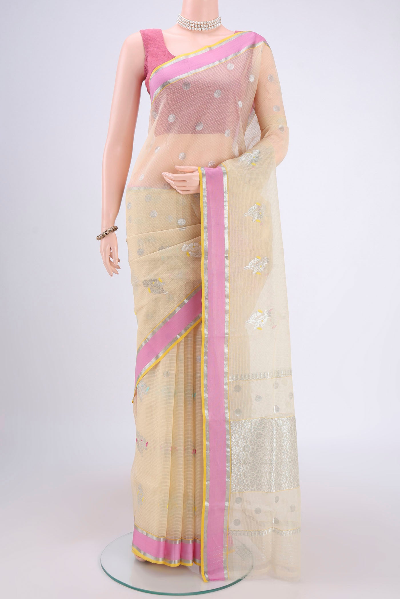 Pure Silk Pure Zari Cream Kota Saree with Zari Butta on the body and Zari Border.  displayed on a mannequin