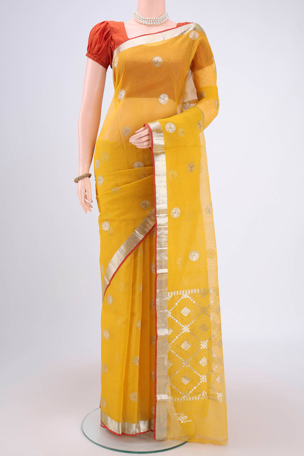 Pure Silk Pure Zari Cream Kota Saree with Zari Butta on the body and Zari Border.  displayed on a mannequin