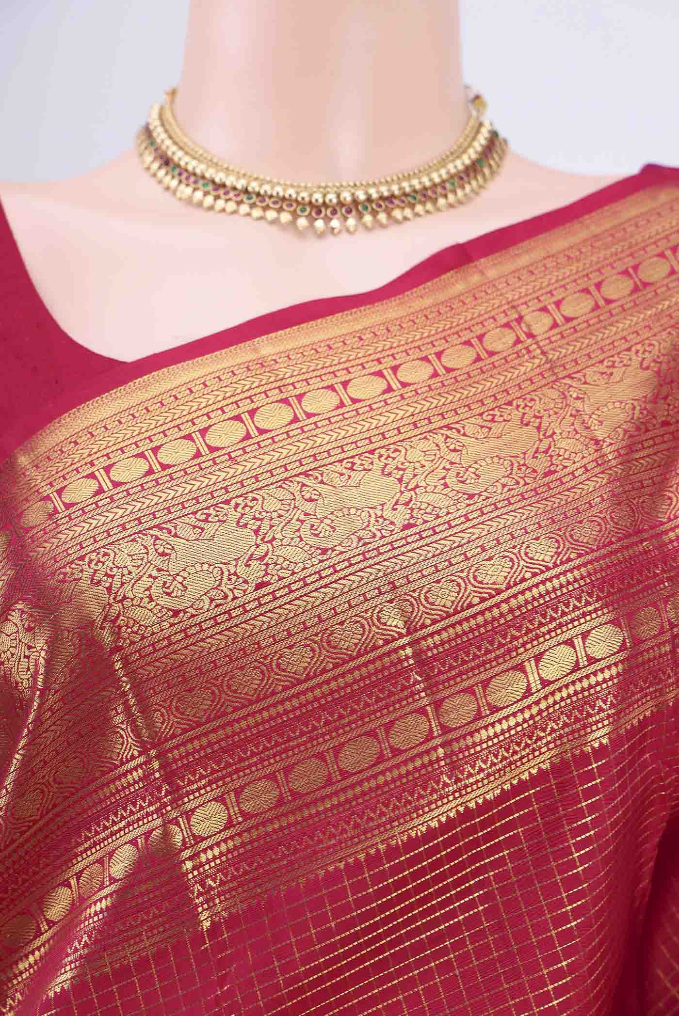 Border image of Maroon Kanjivaram Saree with Checked design on the body and Zari Border. 