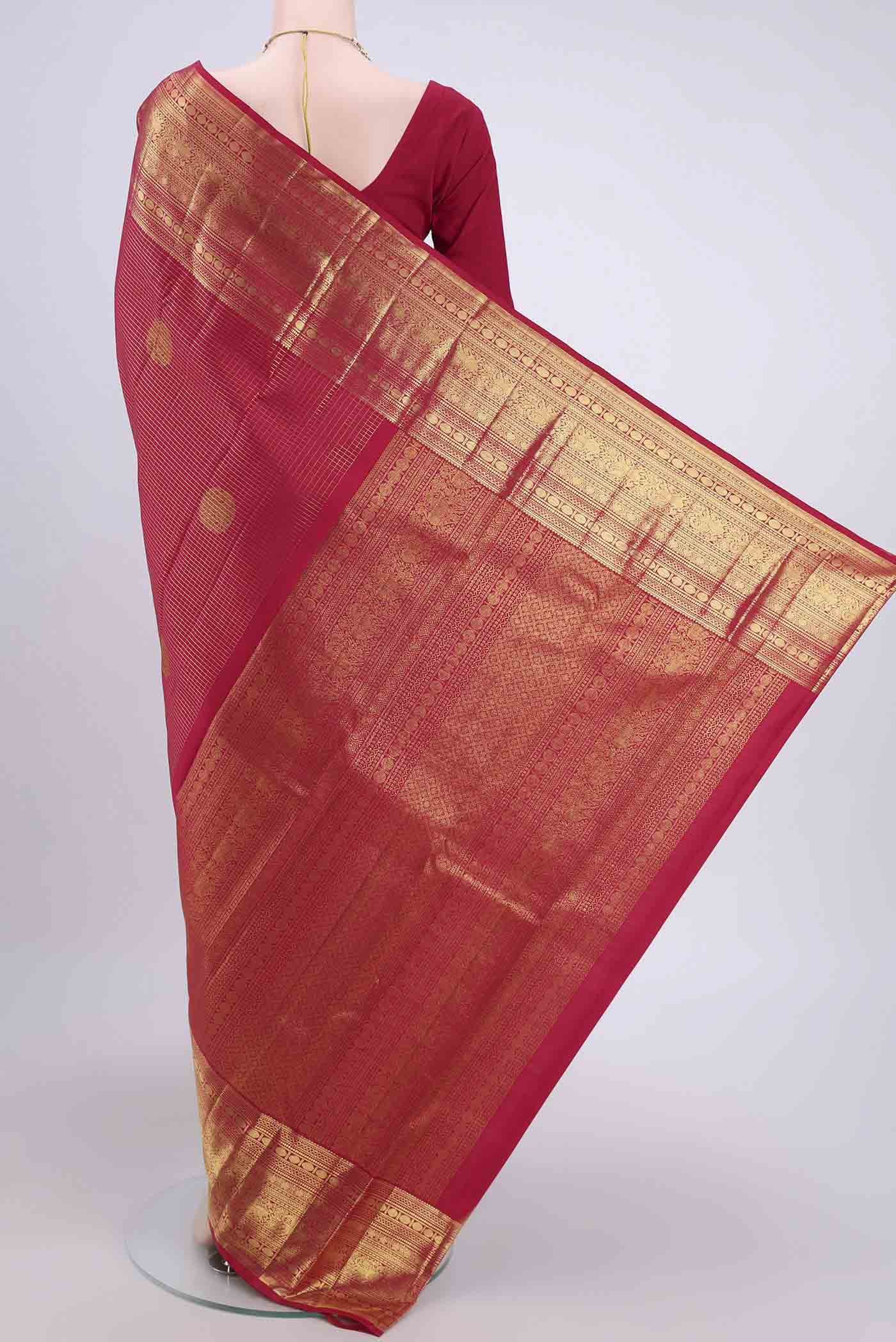 Flat view of Maroon Kanjivaram Saree with Checked design on the body and Zari Border. 