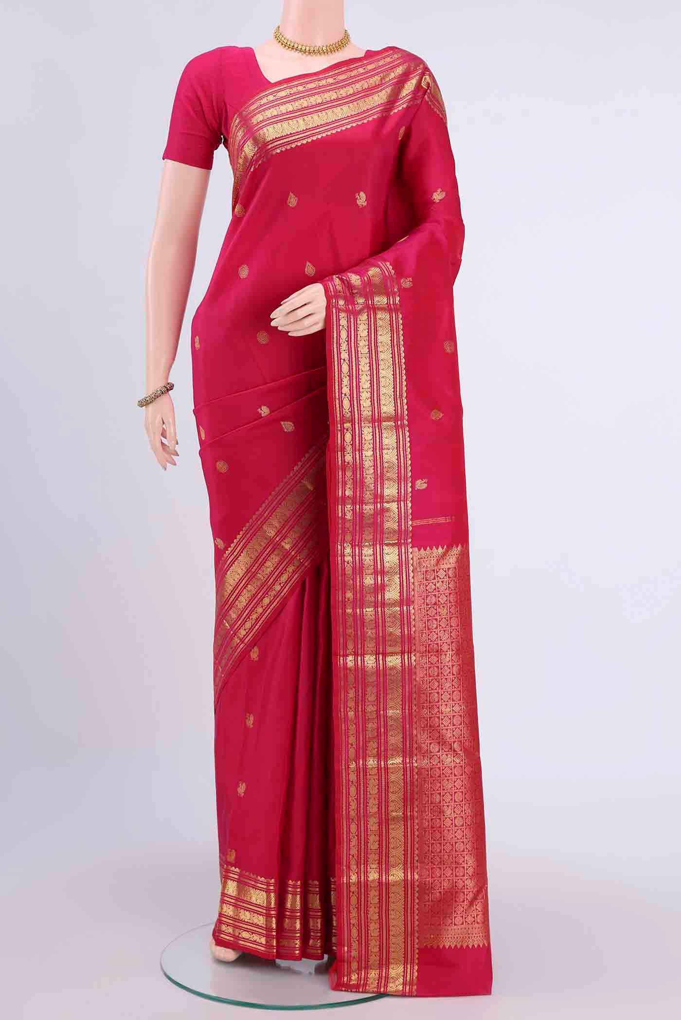 Dark Pink Kanchipuram Silk Saree with Zari Butta on the body and Zari Border displayed on a mannequin