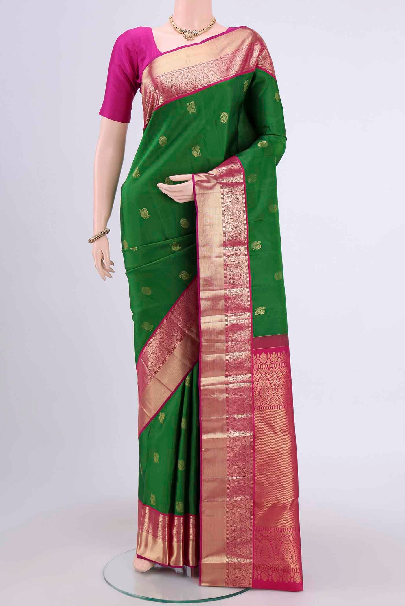 Green Kanchipuram Saree with Zari Butta on the body and Zari Border displayed on a mannequin