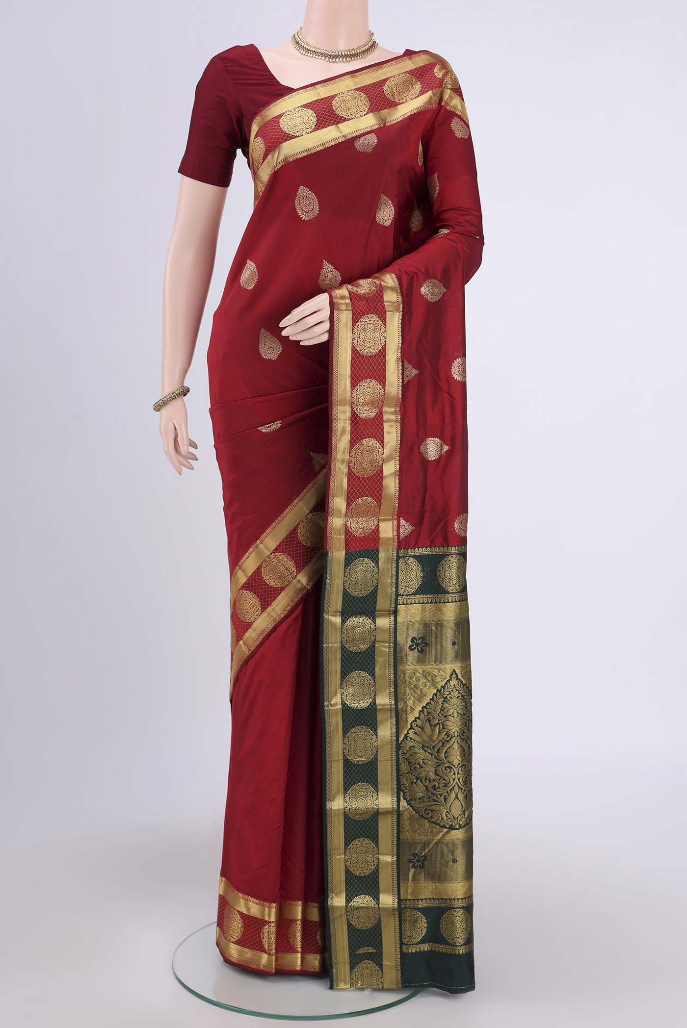 Maroon Blended Bangalore Silk Saree with Zari Butta on the body and Zari Border.  displayed on a mannequin