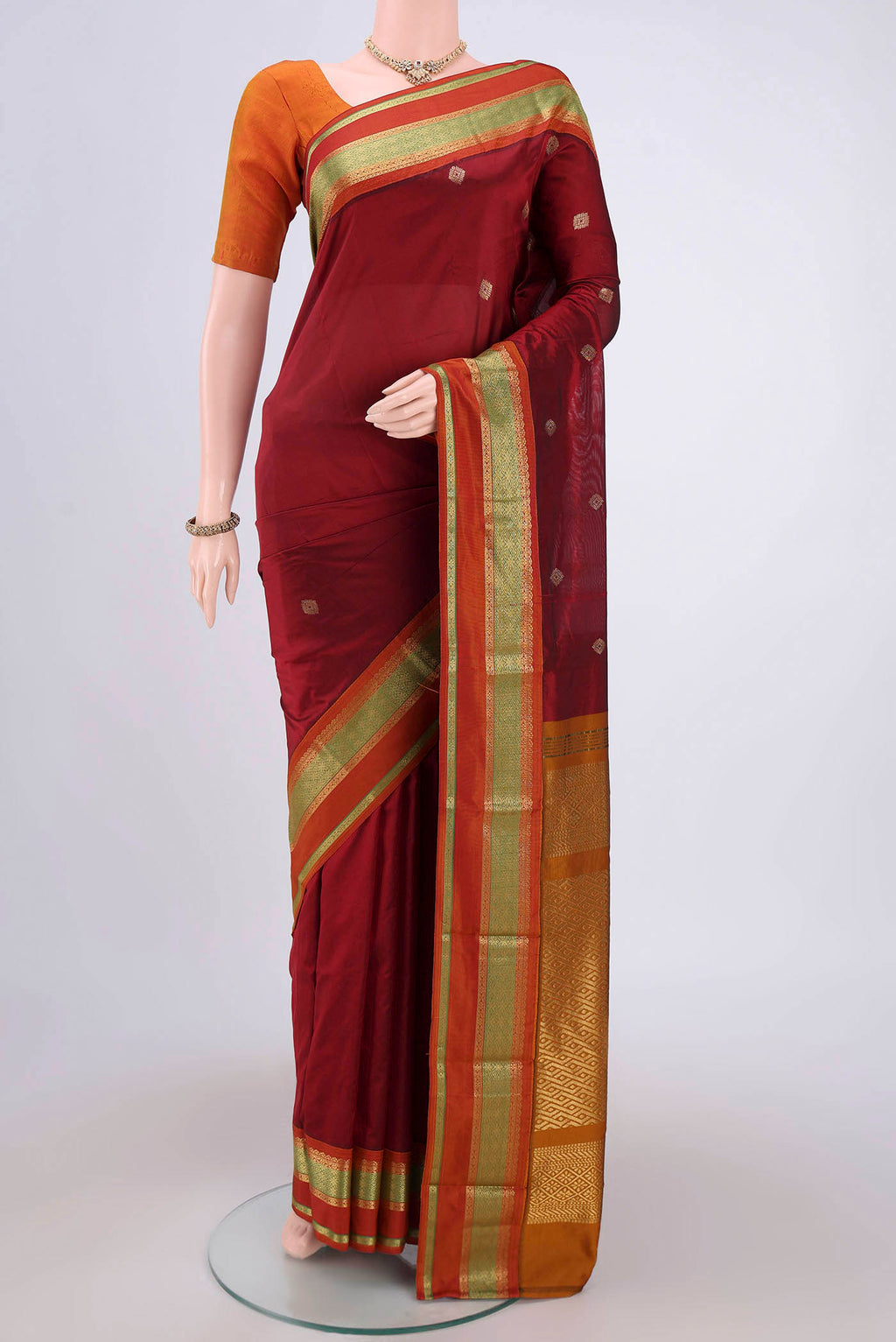 Maroon Blended Bangalore Silk Saree with Zari Butta on the body and Zari Border.  displayed on a mannequin