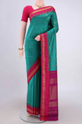 Sea Green Blended Bangalore Silk Saree with Zari Butta on the body and Zari Border.  displayed on a mannequin