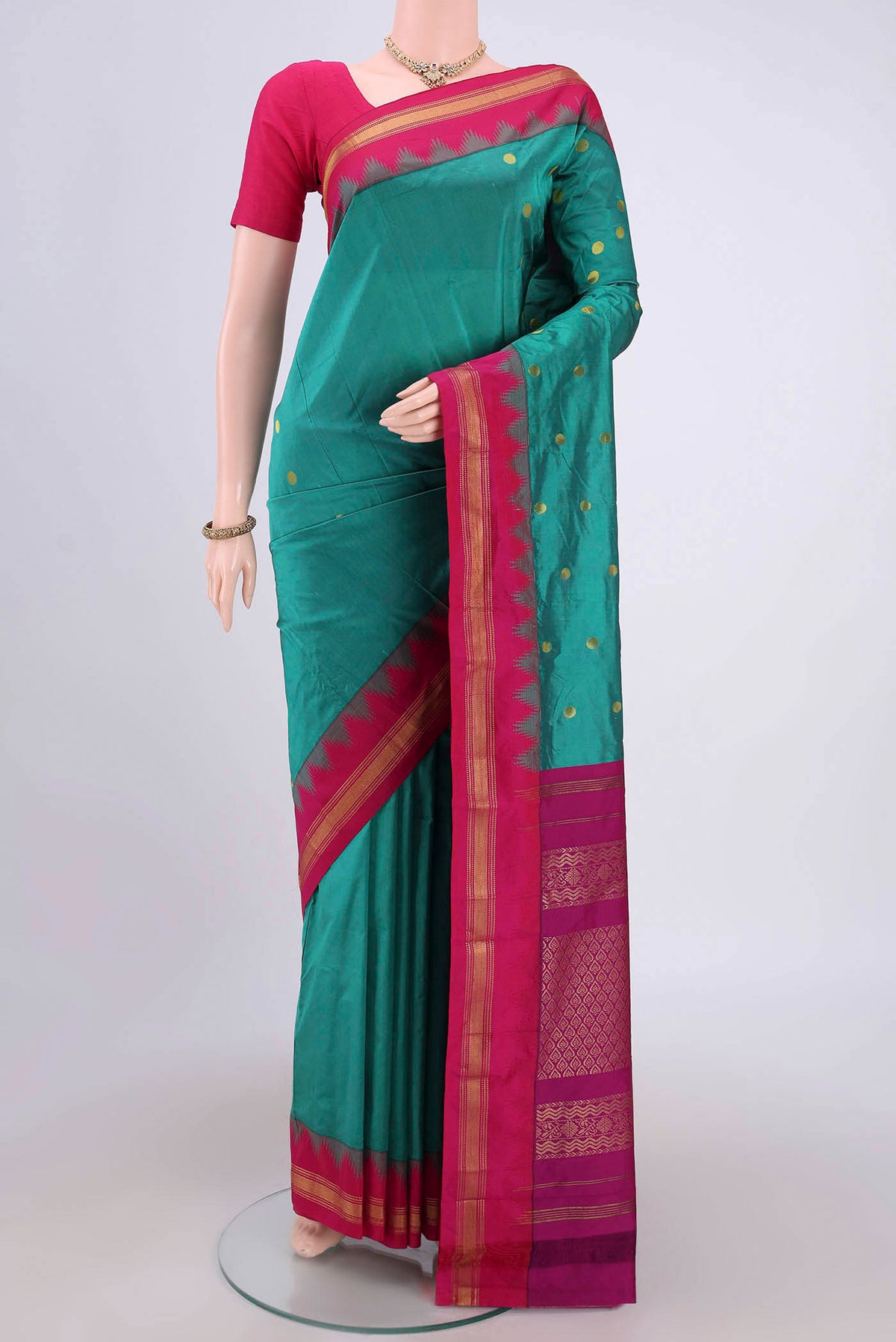 Sea Green Blended Bangalore Silk Saree with Zari Butta on the body and Zari Border.  displayed on a mannequin