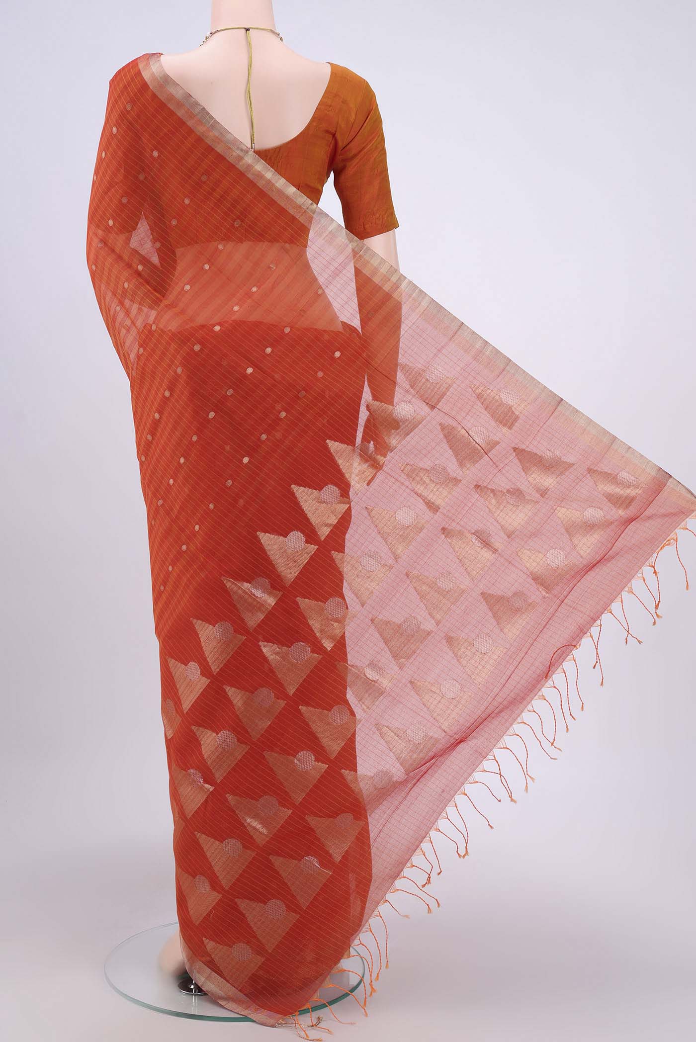 Flat view of Brick Orange Kora Cotton Saree with Zari Butta on the body and Zari Border. 