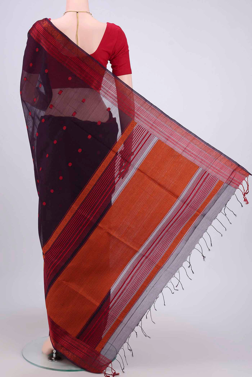 Flat view of Dark Mauve Kora Cotton Saree with Zari Butta on the body and Zari Border. 