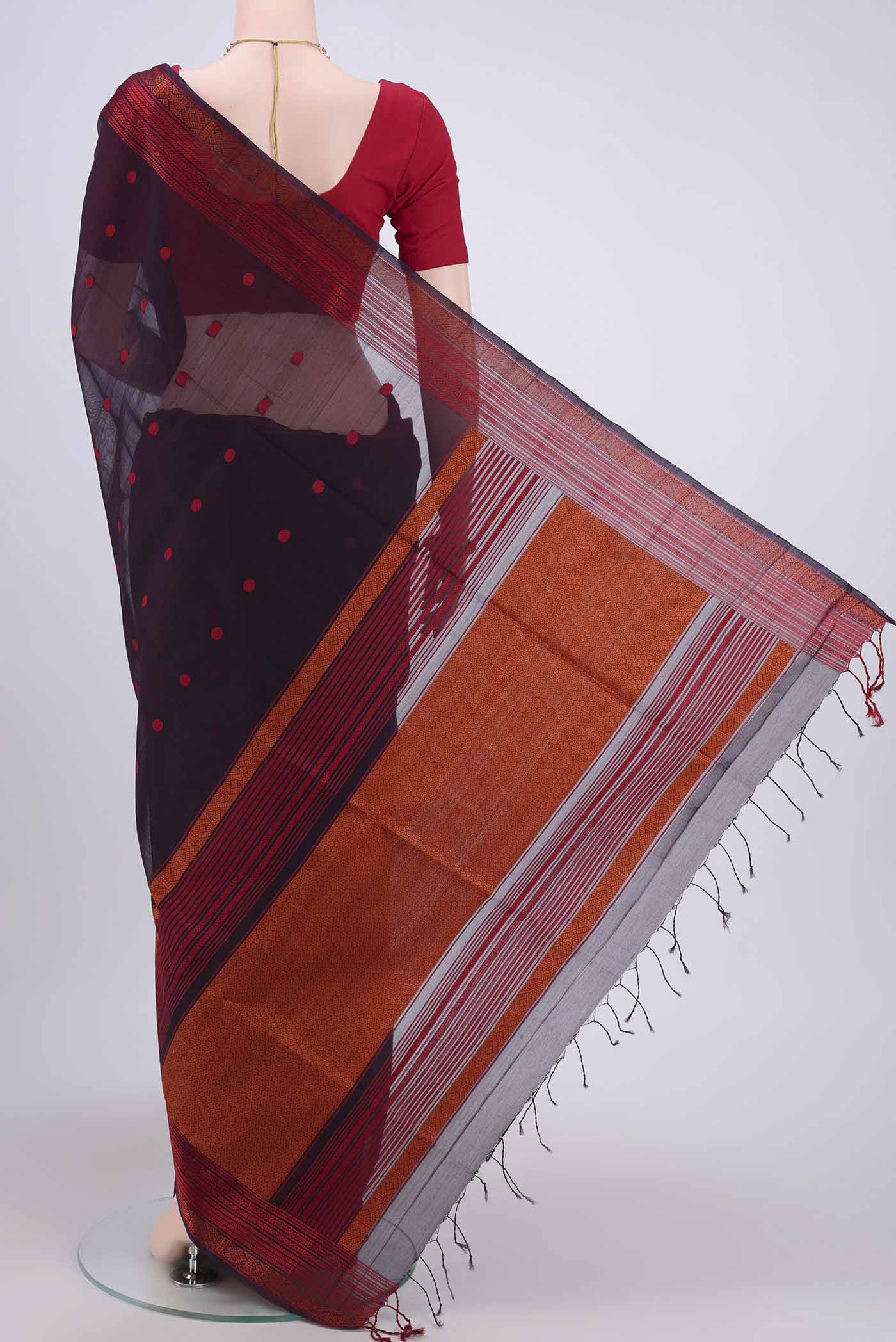 Flat view of Dark Mauve Kora Cotton Saree with Zari Butta on the body and Zari Border. 