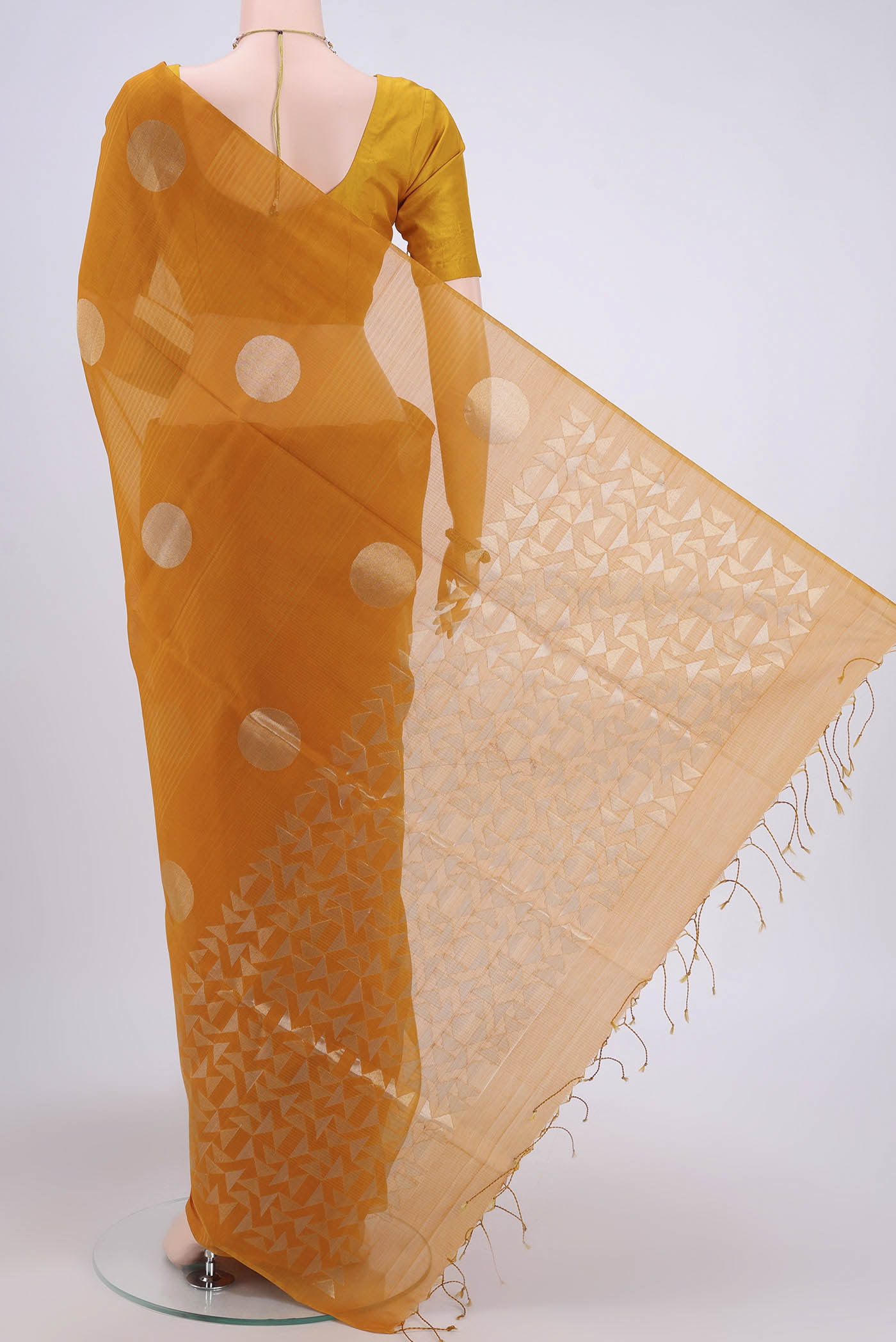 Flat view of Mustard Kora Cotton Saree with Zari Butta on the body and Zari Border. 