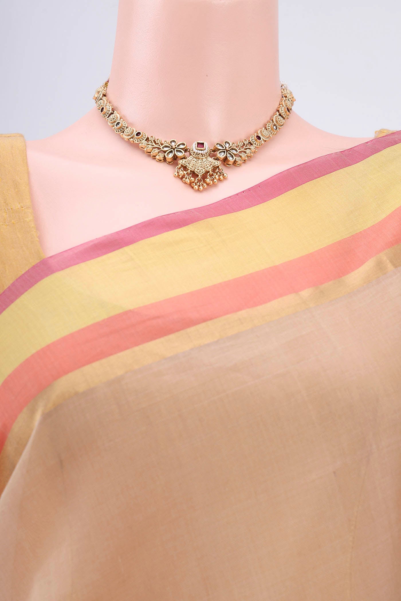 Border image of Beige Kora Cotton Saree with Zari Butta on the body and Plain Border. 