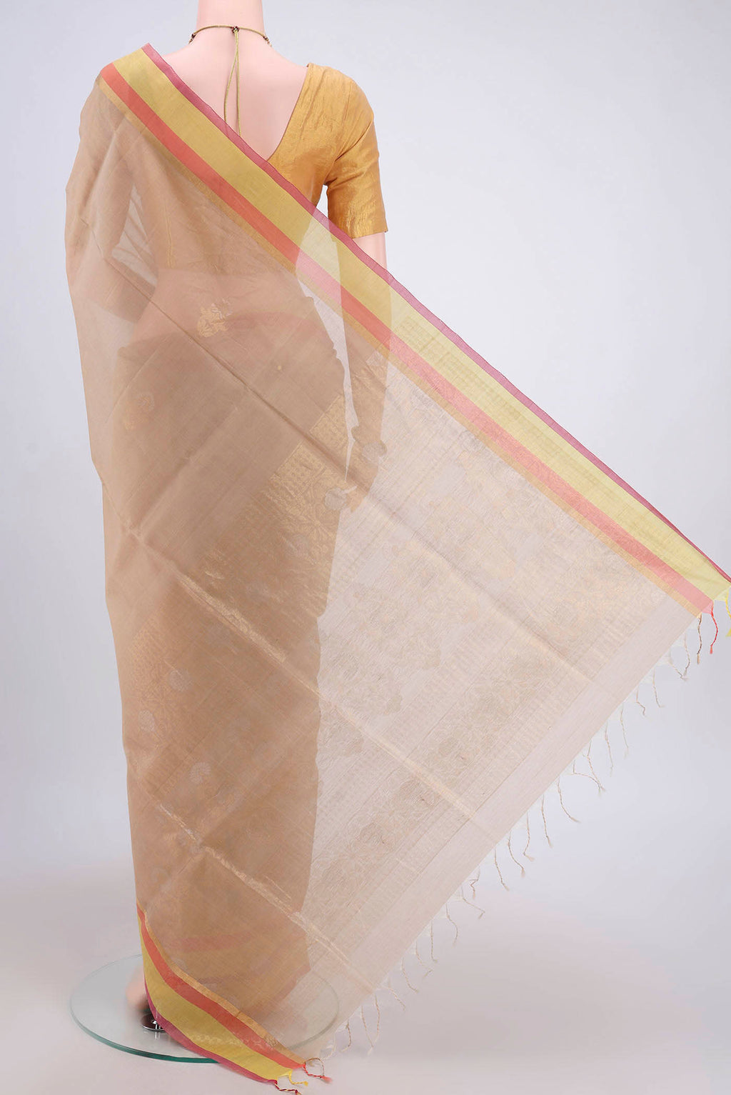 Flat view of Beige Kora Cotton Saree with Zari Butta on the body and Plain Border. 