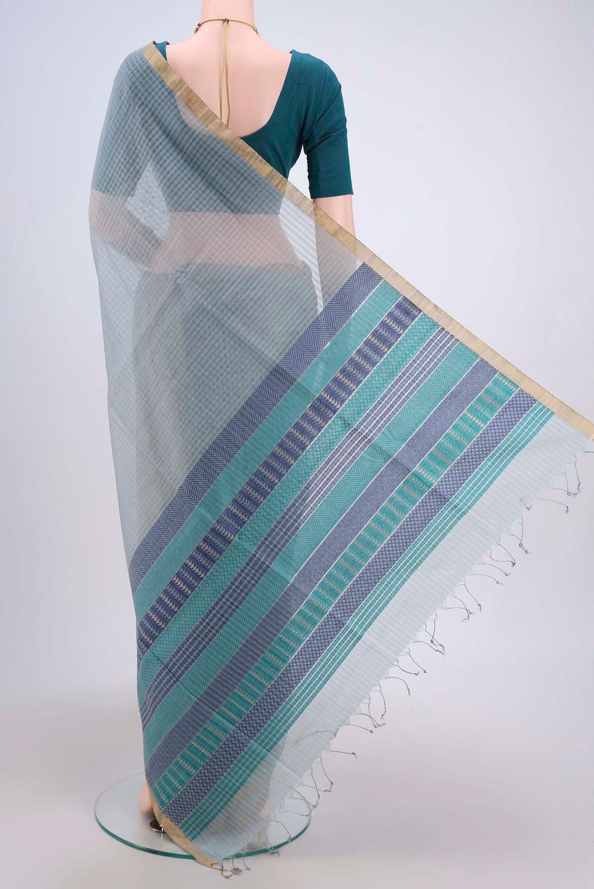 Flat view of Blue Grey Silk Cotton Saree with Plain Body and Zari Border. 