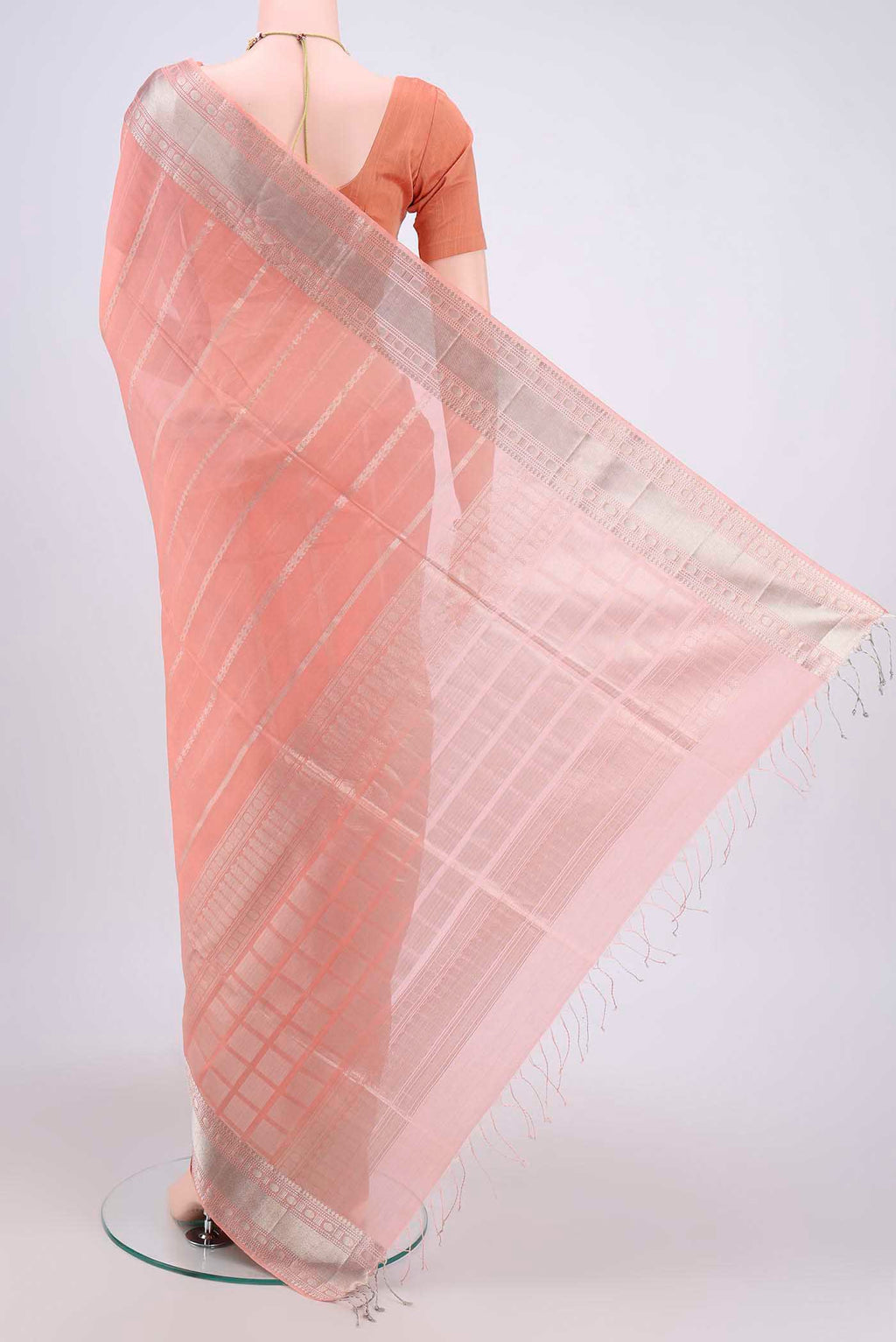 Flat view of Peach Kora Cotton Saree with Zari Butta on the body and Zari Border. 