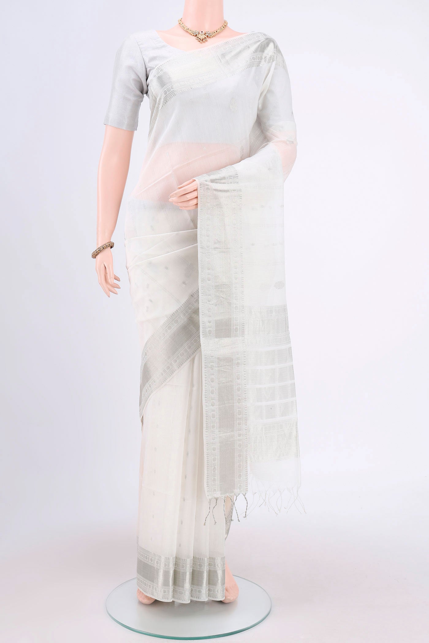White Kora Cotton Saree with Zari Butta on the body and Plain Border.  displayed on a mannequin