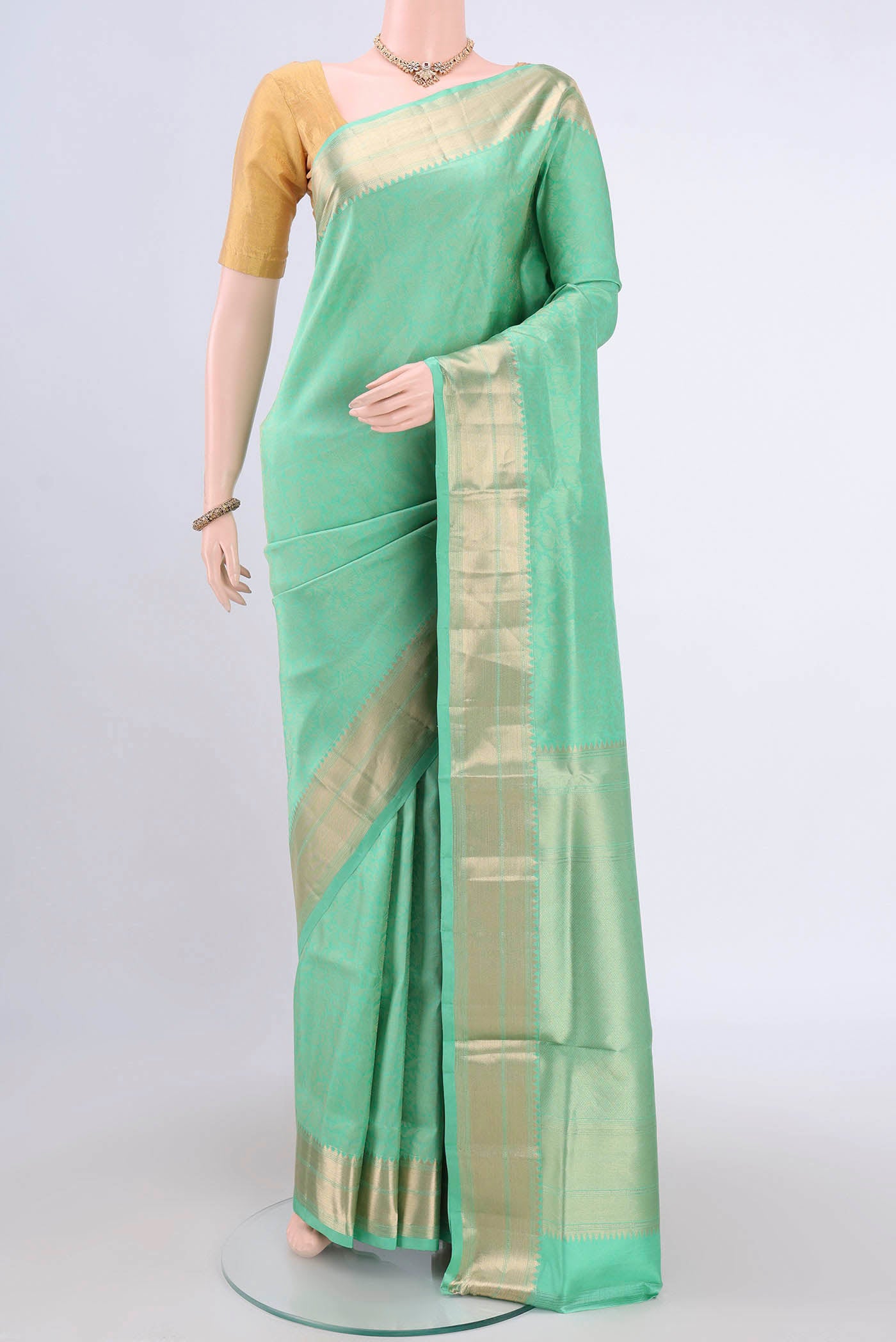 Light Green Soft Silk Saree with Zari Brocade on the body and Zari Border.  displayed on a mannequin