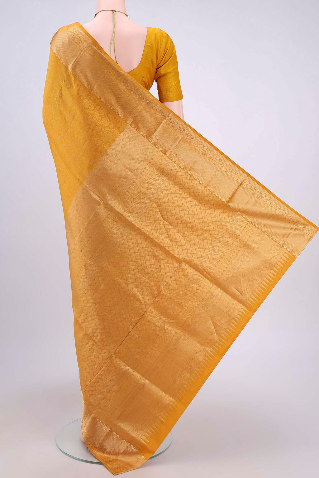 Flat view of Mustard Soft Silk Saree with Zari Brocade on the body and Zari Border. 