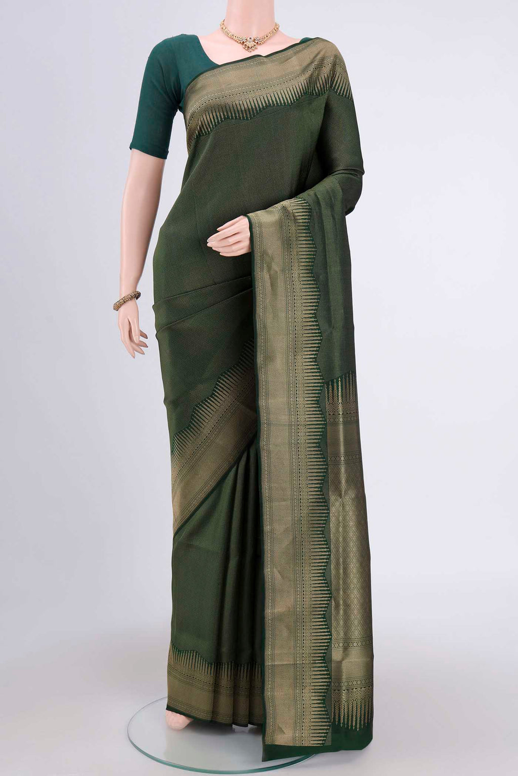 Bottle Green Soft Silk Saree with Checked design on the body and Zari Border.  displayed on a mannequin