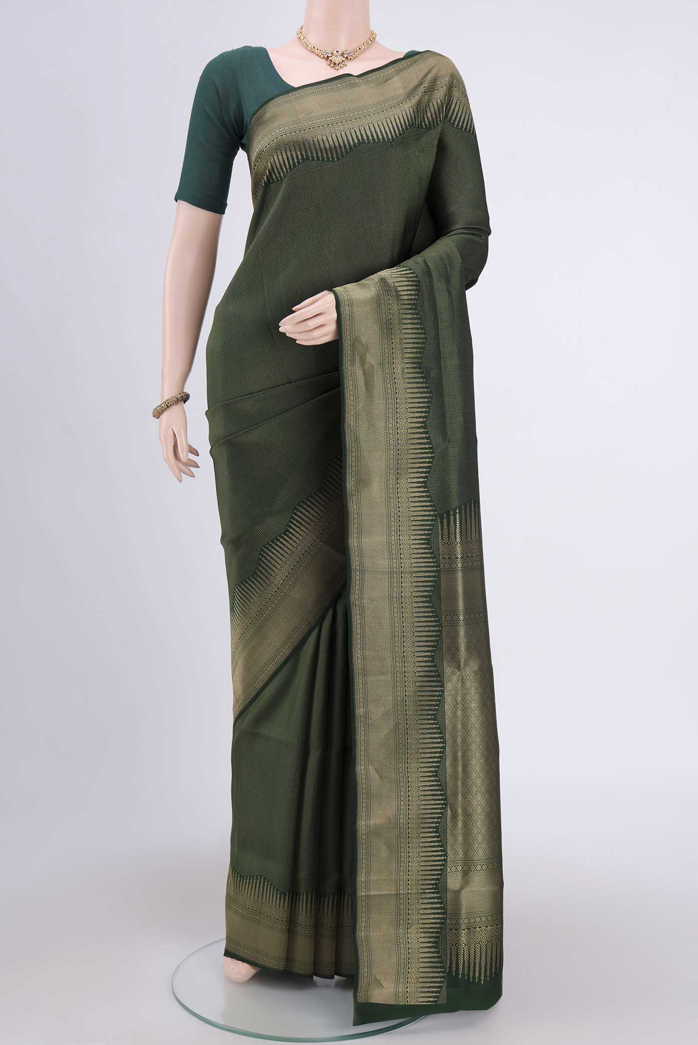 Bottle Green Soft Silk Saree with Checked design on the body and Zari Border.  displayed on a mannequin