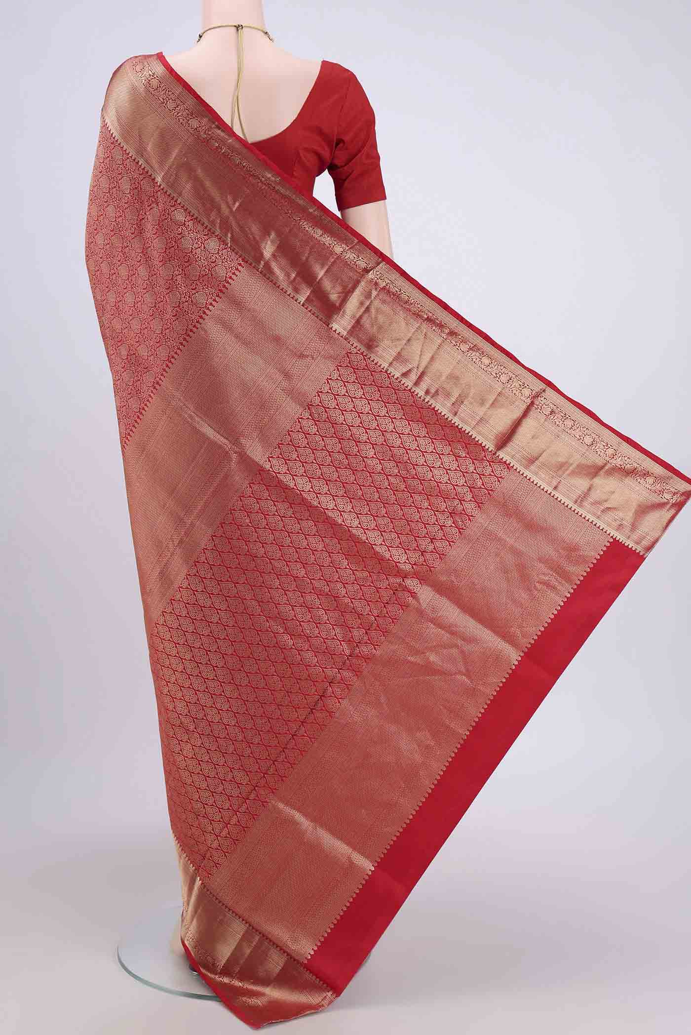 Flat view of Red Soft Silk Saree with Zari Brocade on the body and Zari Border. 