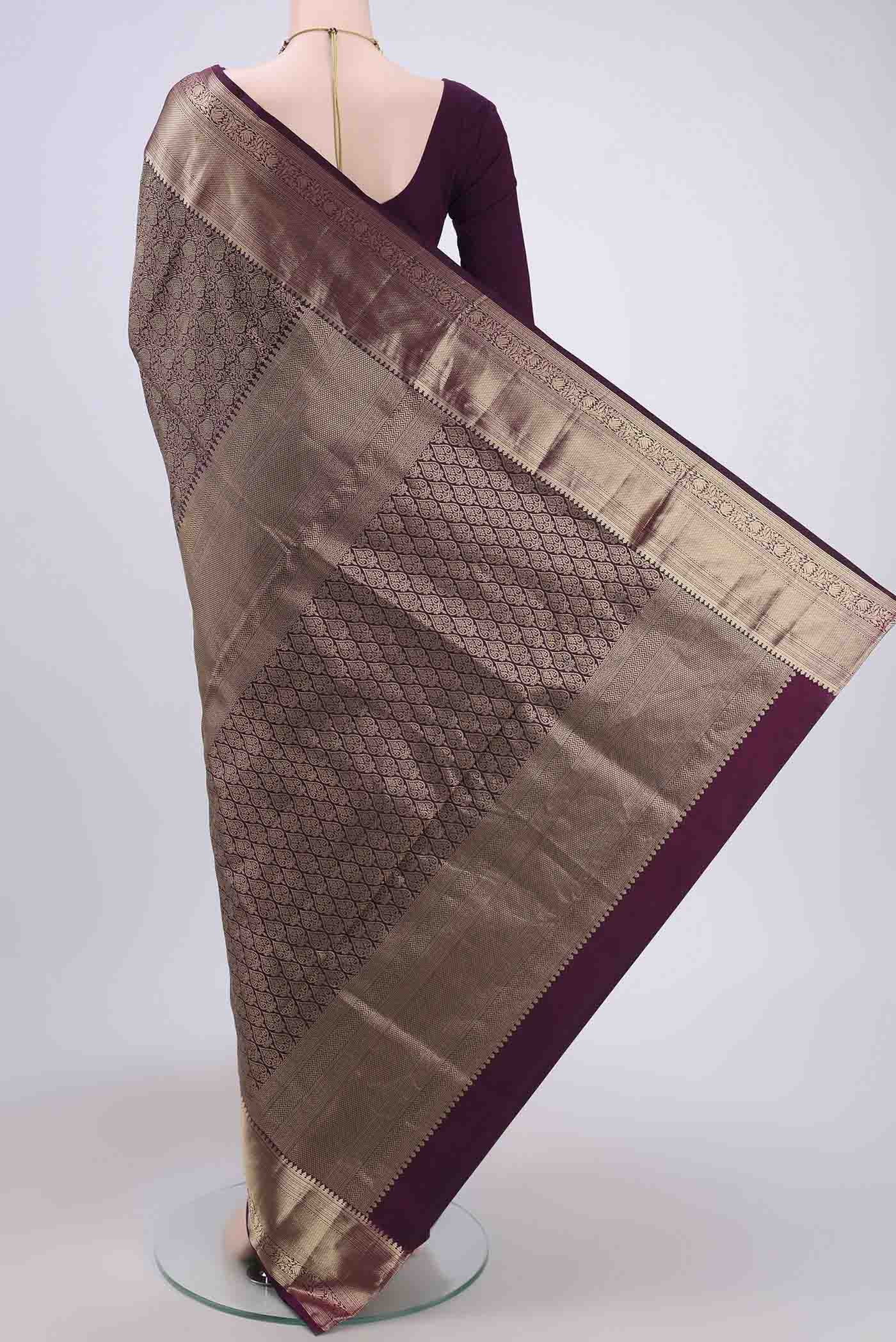 Flat view of Dark Mauve Soft Silk Saree with Zari Brocade on the body and Zari Border. 