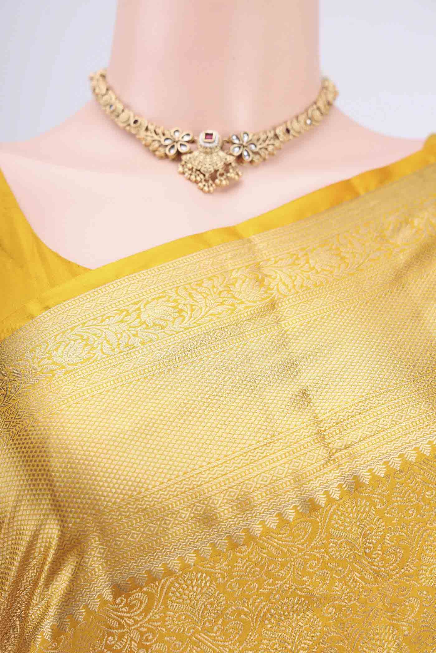 Border image of Mustard Soft Silk Saree with Zari Brocade on the body and Zari Border. 