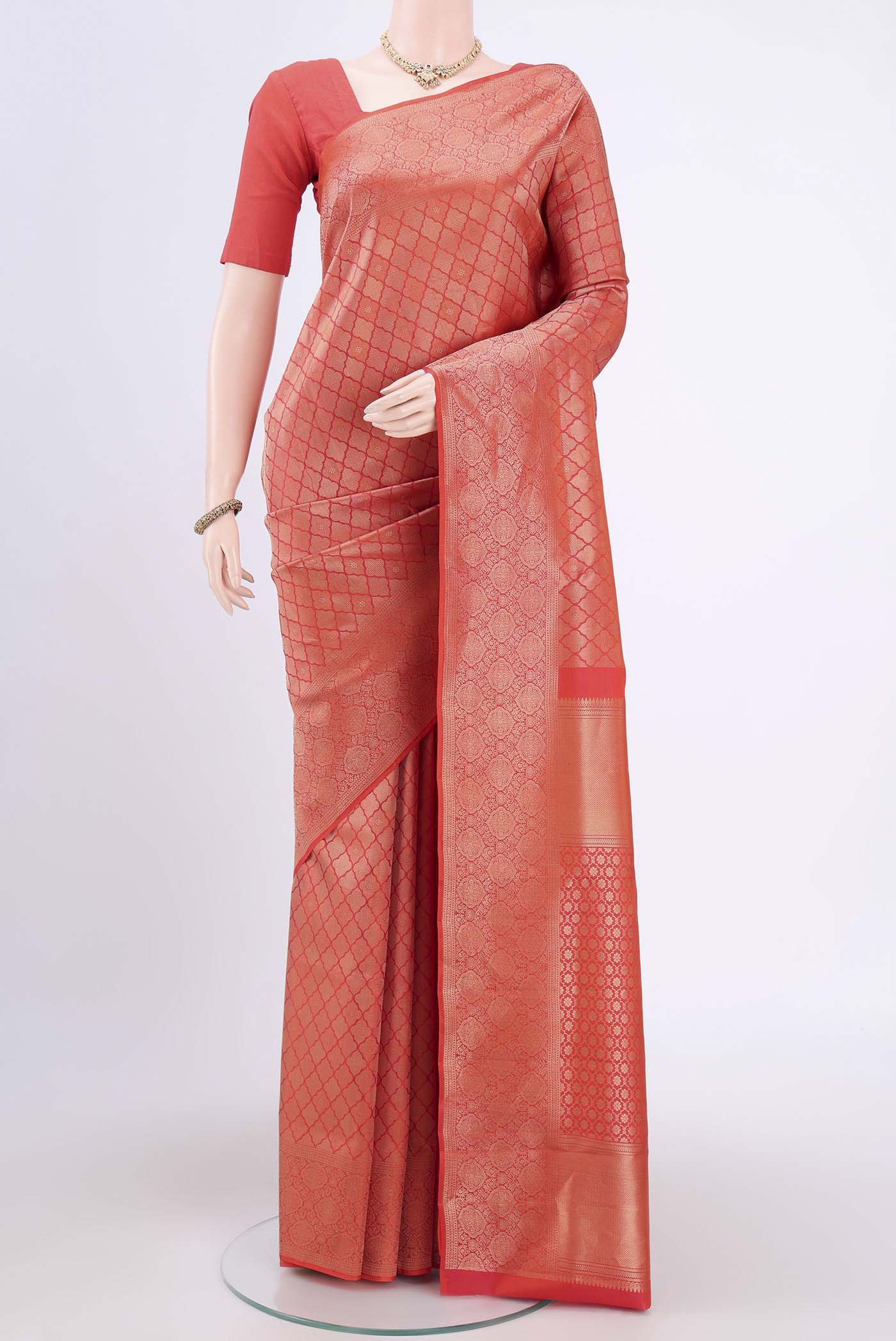 Brick Orange Soft Silk Saree with Zari Brocade on the body and Zari Border.  displayed on a mannequin