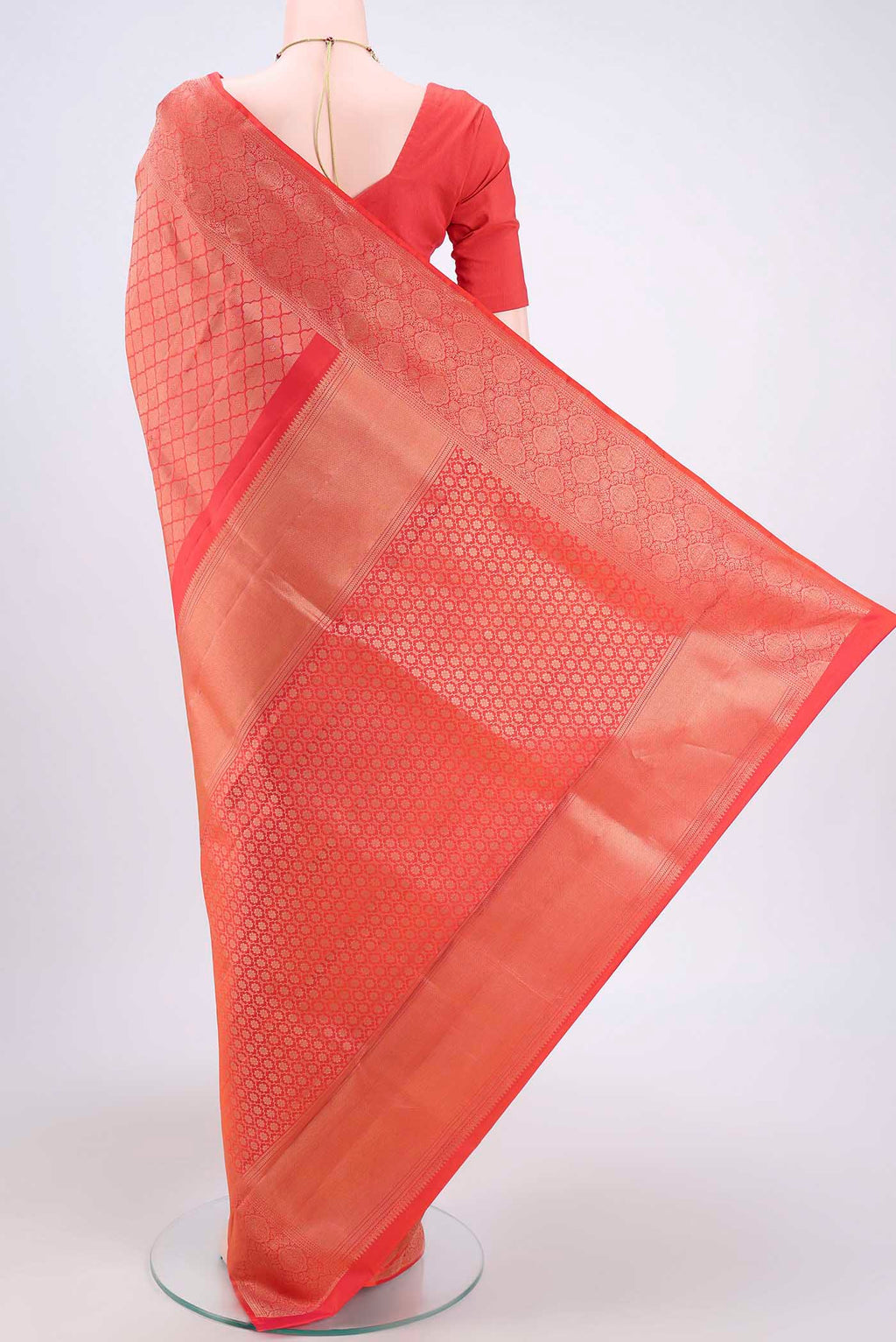 Flat view of Brick Orange Soft Silk Saree with Zari Brocade on the body and Zari Border. 