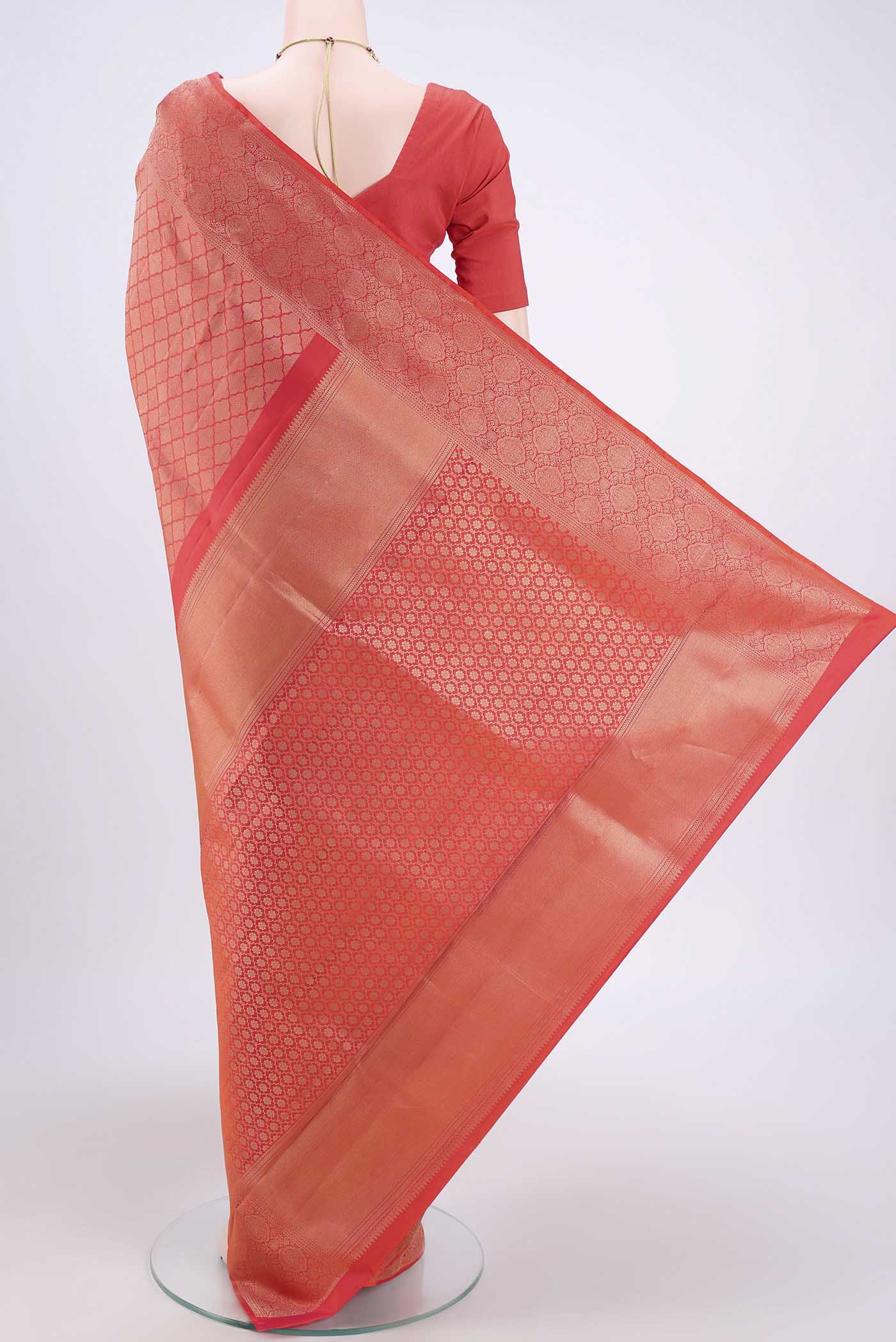 Flat view of Brick Orange Soft Silk Saree with Zari Brocade on the body and Zari Border. 
