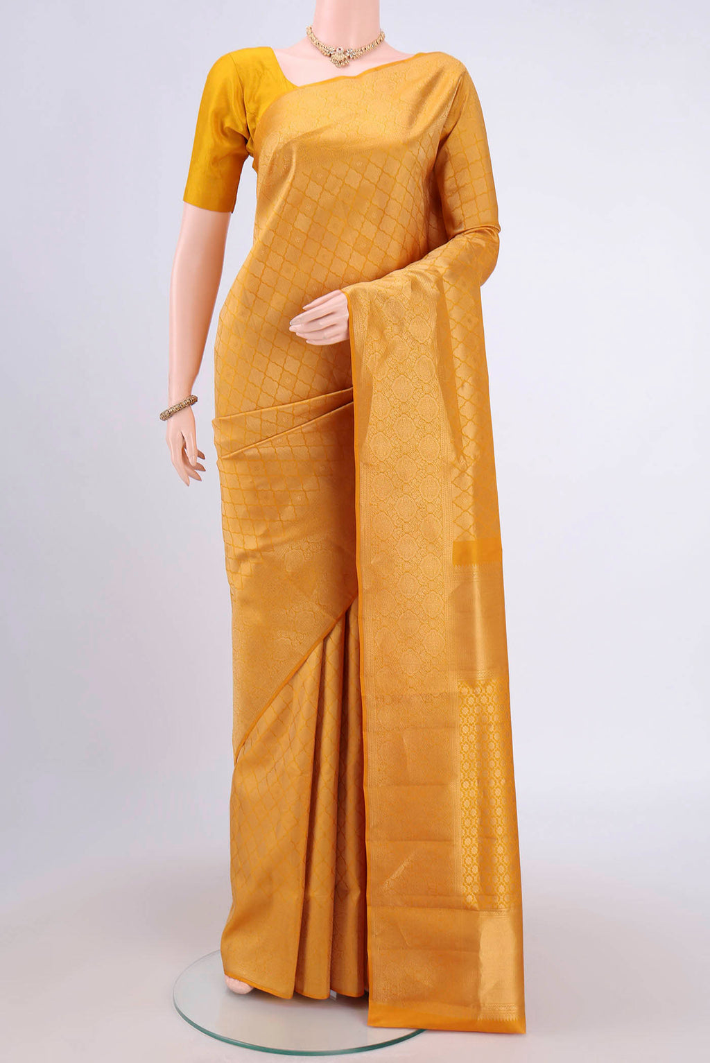 Mustard Soft Silk Saree with Zari Brocade on the body and Zari Border.  displayed on a mannequin