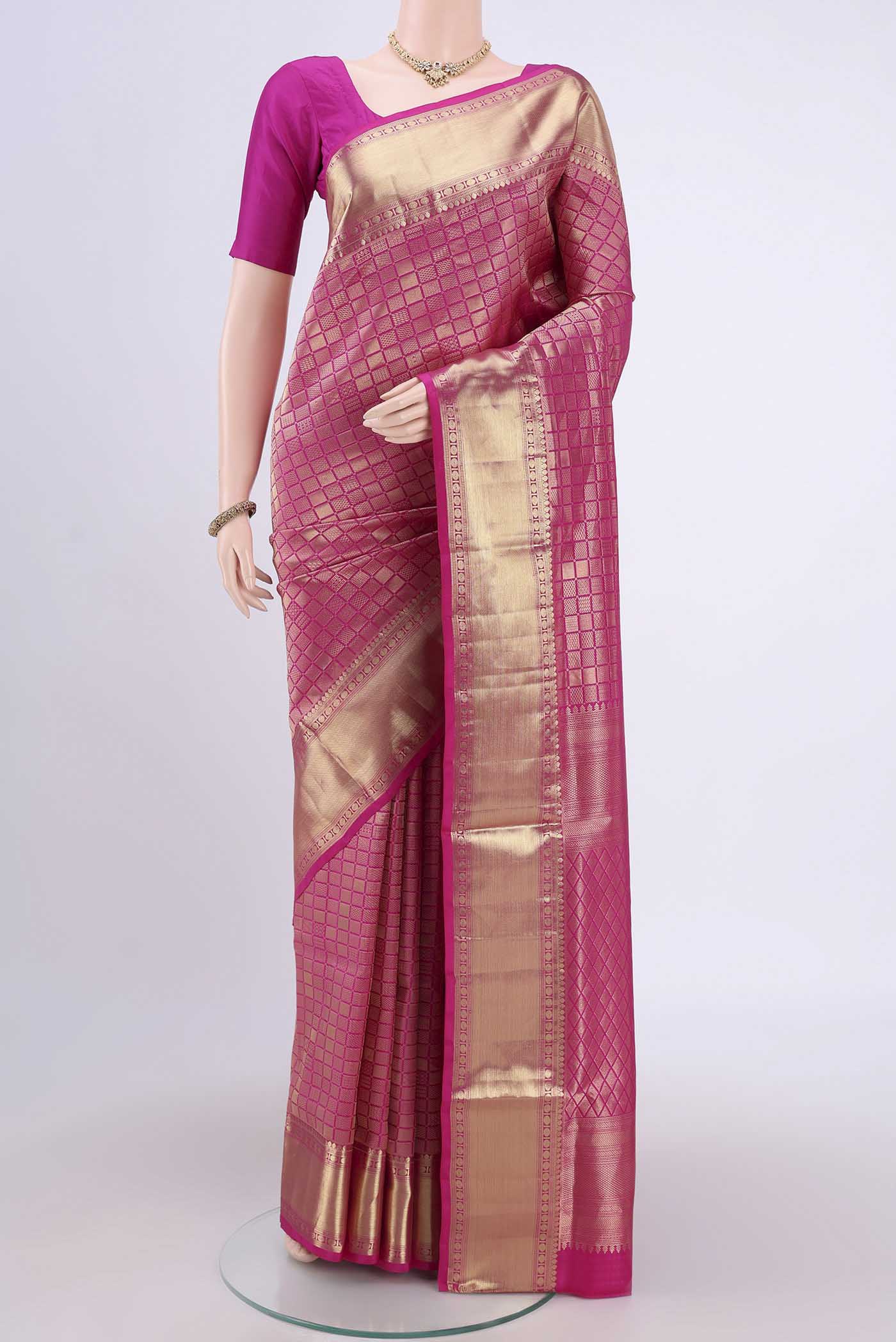 Rani Pink Soft Silk Saree with Zari Brocade on the body and Zari Border.  displayed on a mannequin