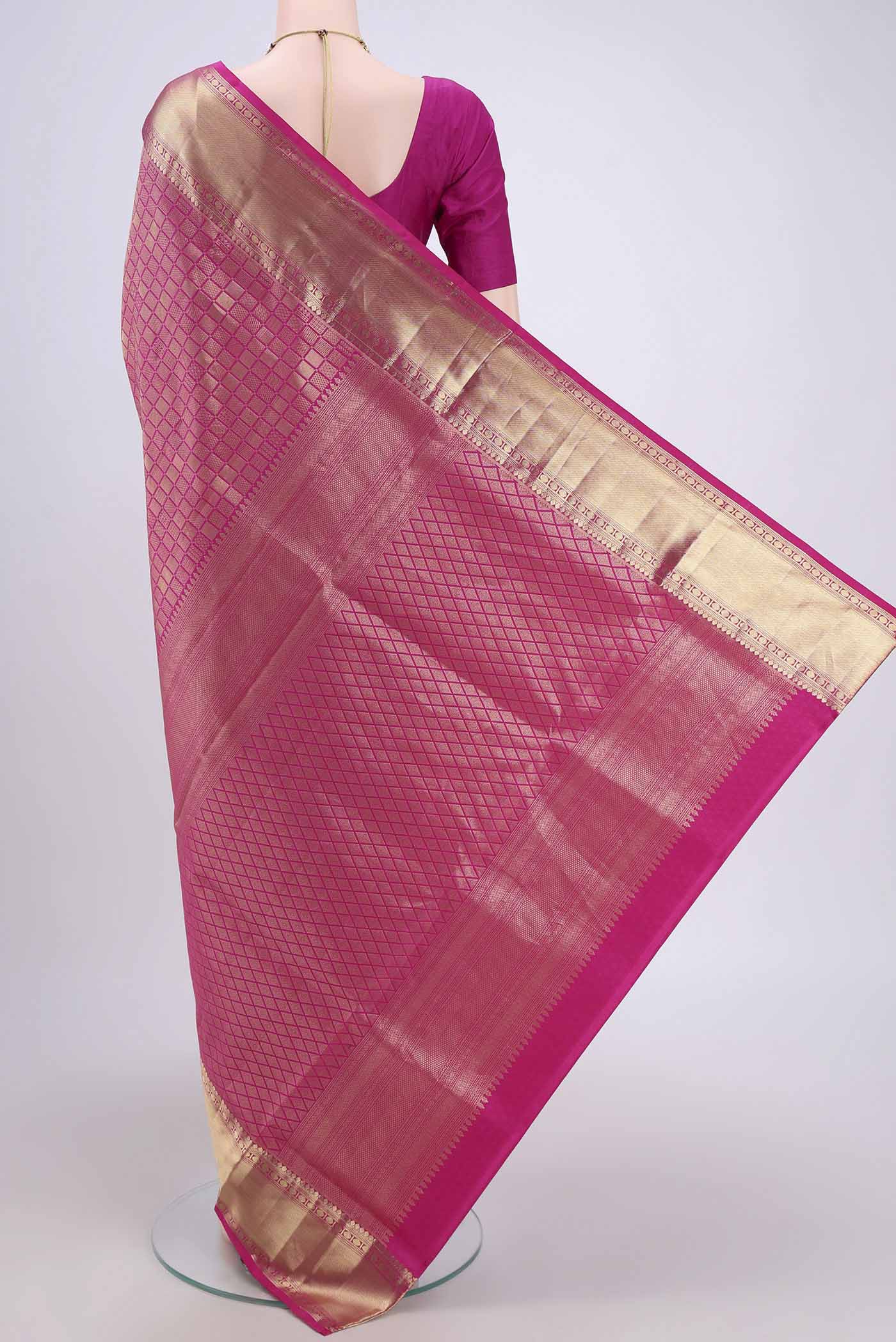 Flat view of Rani Pink Soft Silk Saree with Zari Brocade on the body and Zari Border. 