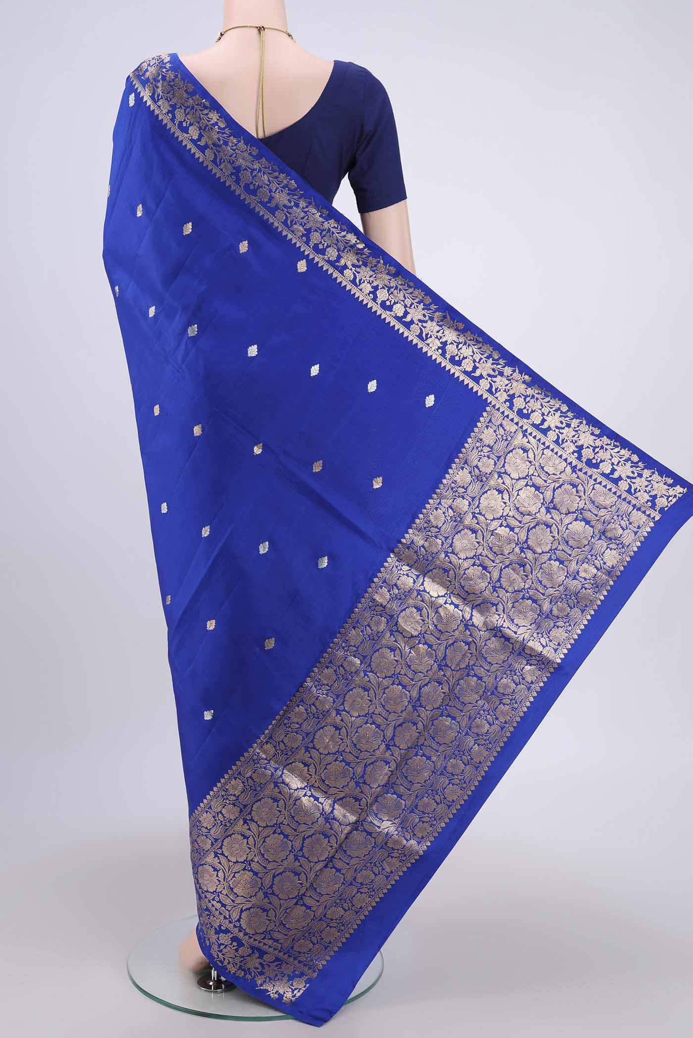 Flat view of Royal Blue Banarasi Katan Silk Saree with Zari Butta on the body and Zari Border. 