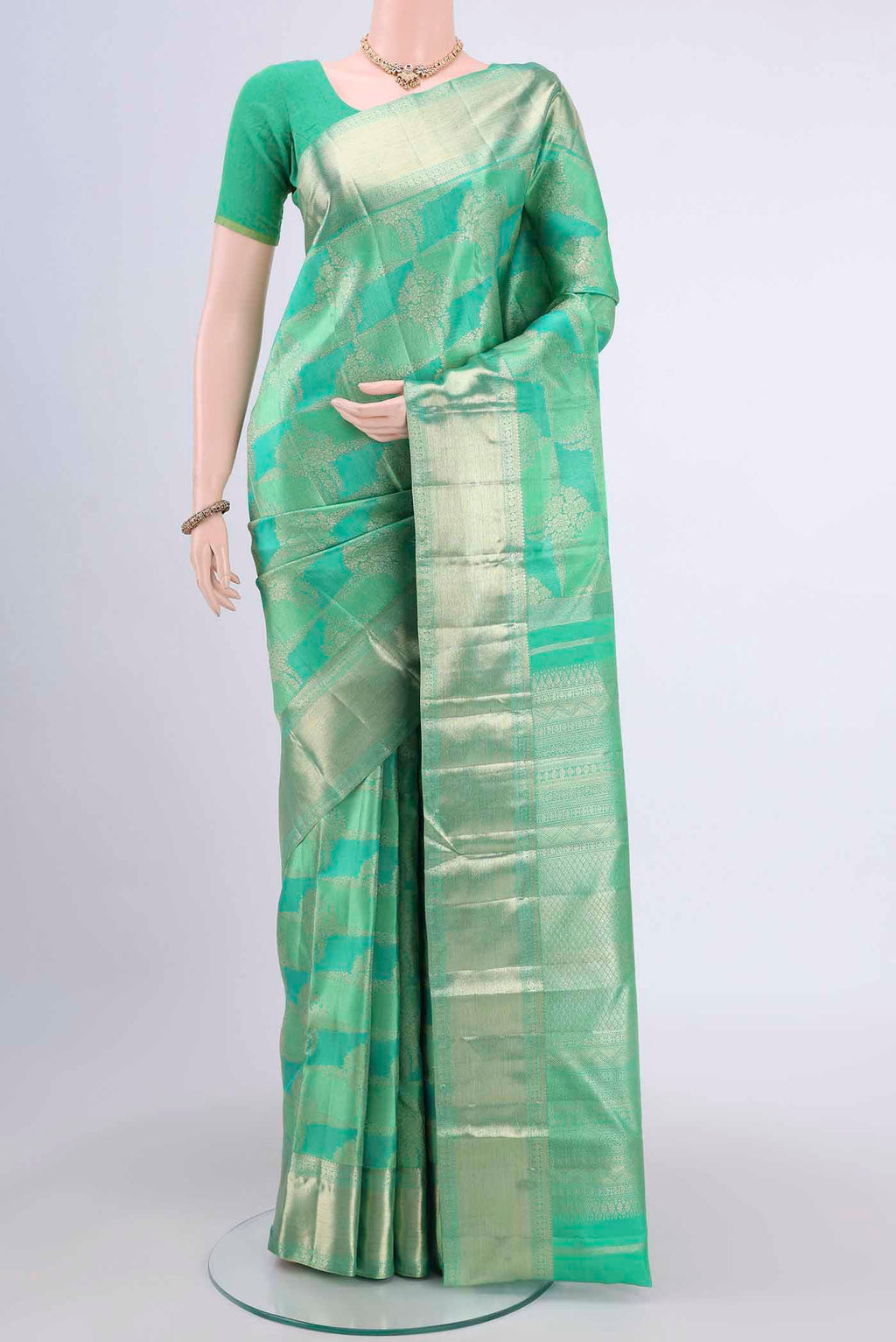 Mint Green Dual Tone Kanchipuram Saree with Zari Brocade on the body and Zari Border displayed on a mannequin
