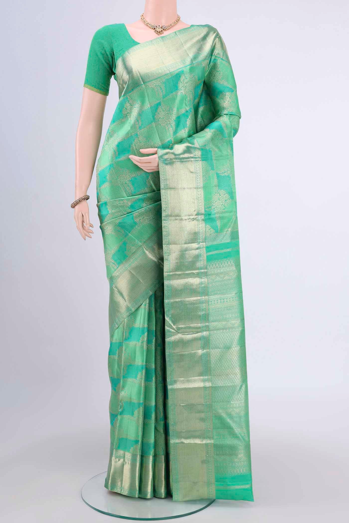 Mint Green Dual Tone Kanchipuram Saree with Zari Brocade on the body and Zari Border displayed on a mannequin