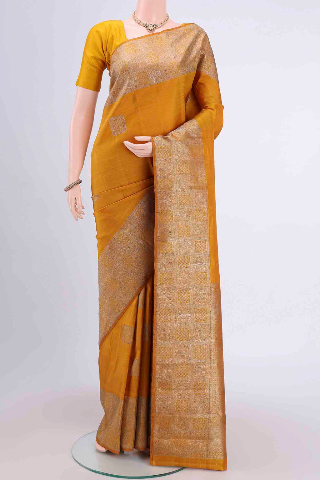 Mustard Dual Tone Kanchipuram Saree with Zari Butta on the body and Zari Border displayed on a mannequin