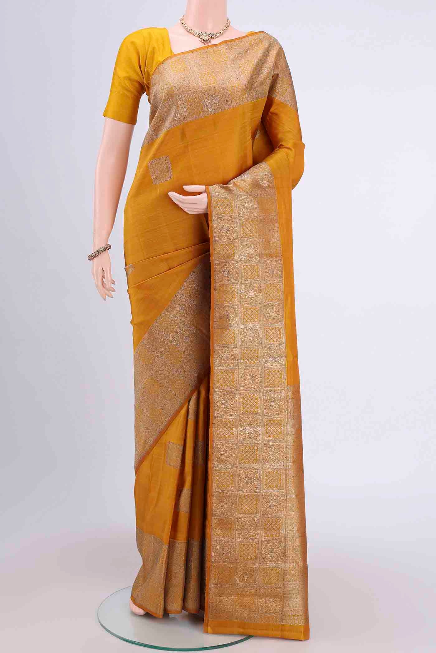 Mustard Dual Tone Kanchipuram Saree with Zari Butta on the body and Zari Border displayed on a mannequin
